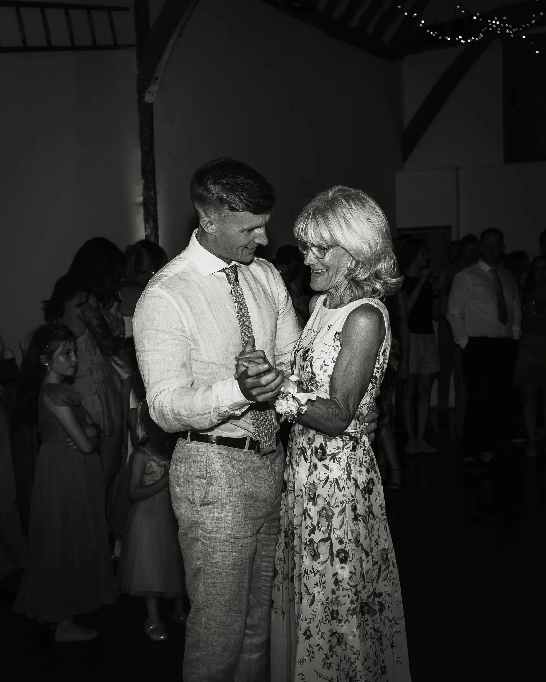 A heartfelt moment as the Groom dances with his Mother during a wedding day at Winters Barns, captured and told in a black and white aesthetic.