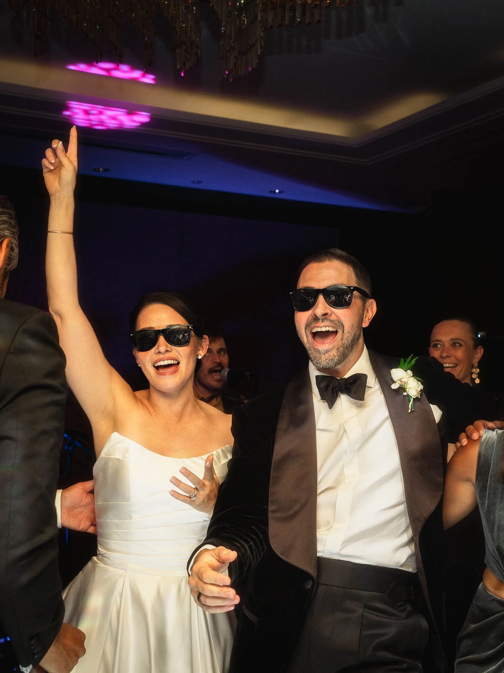 A bride and groom wear su glasses on the dance floor as they lead after party celebrations during their luxury London wedding say at the Shangri-La hotel at the Shard.
