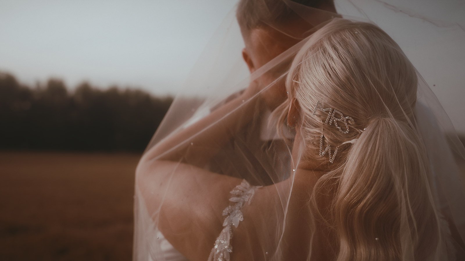 A cinematic moment as the couple share an intimate moment in the fields surrounding Winters Barns at golden hour.
