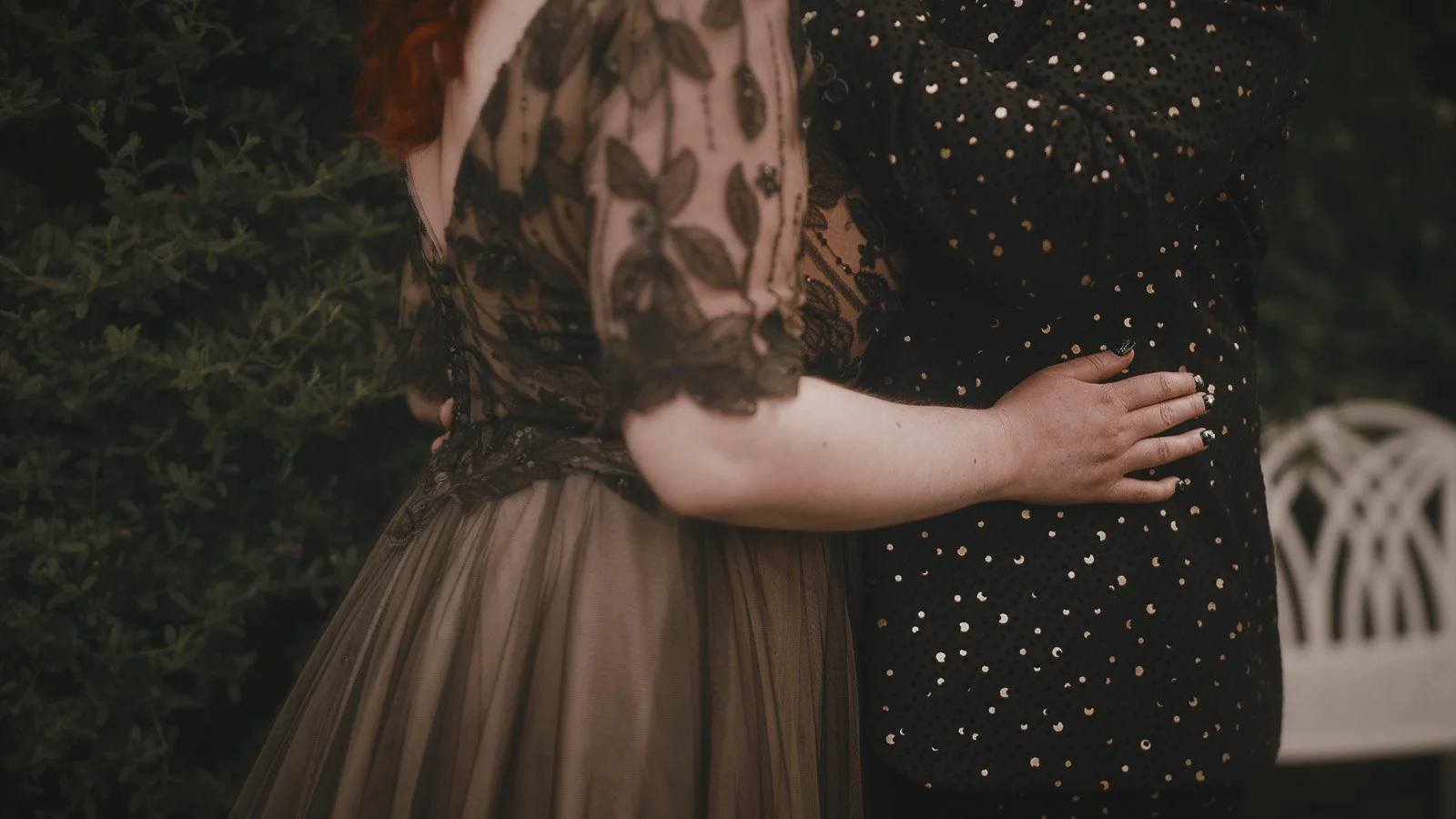 Bride’s black lace dress details photographed in a cinematic, editorial style
