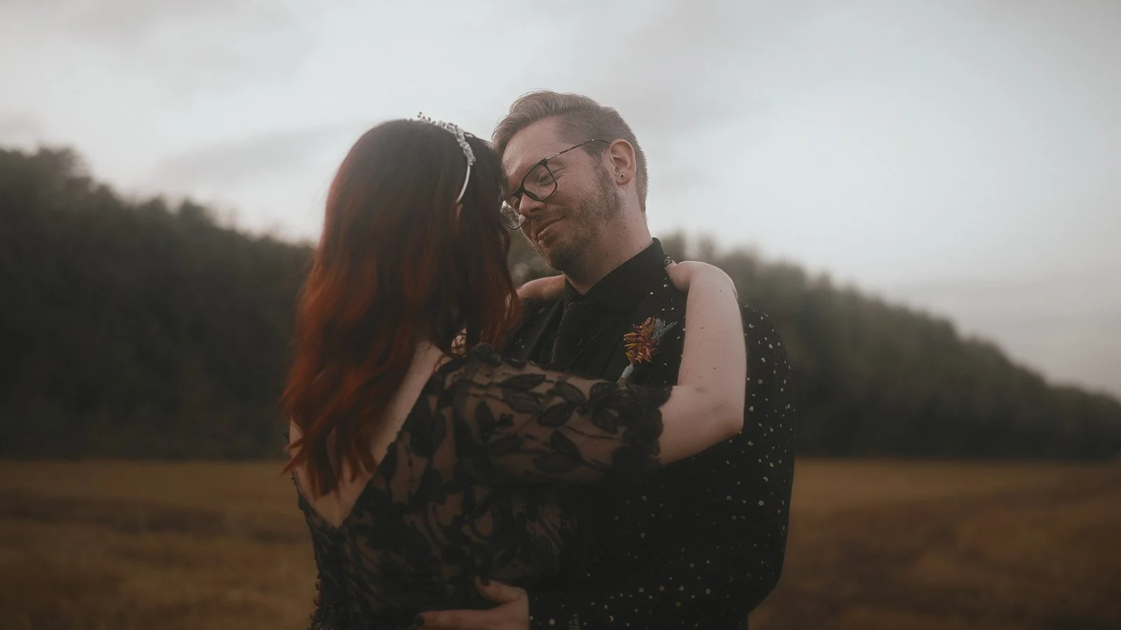 An alternative gothic couple share an intimate moment in their wedding video at Winters Barns, Kent.