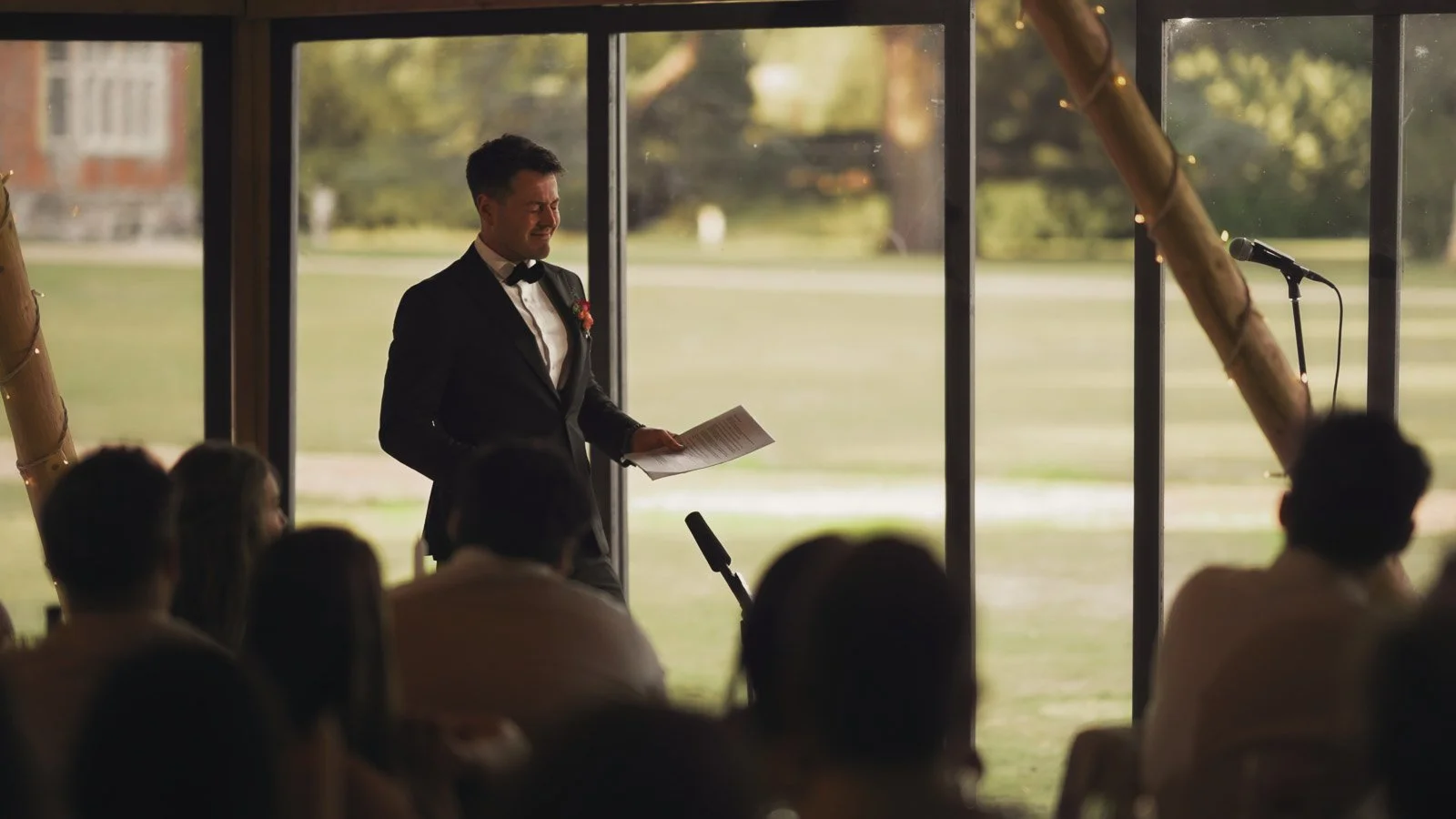 Speeches during a marquee reception at an Oxfordshire Estate on a colourful riverside wedding day.