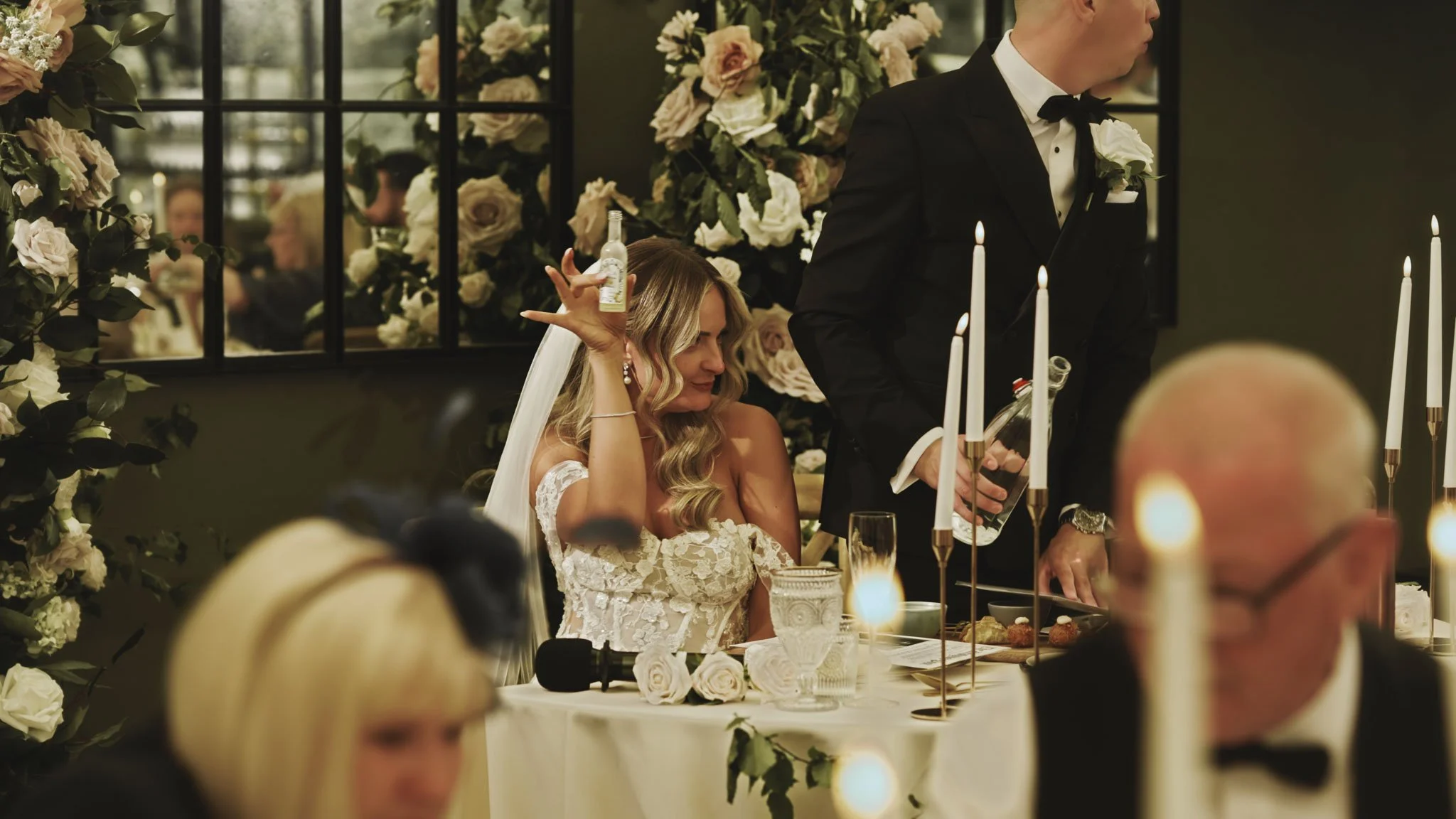Guests reacting during wedding speeches in the Port Lympne Glass Orangery, capturing laughter and emotion in the room.