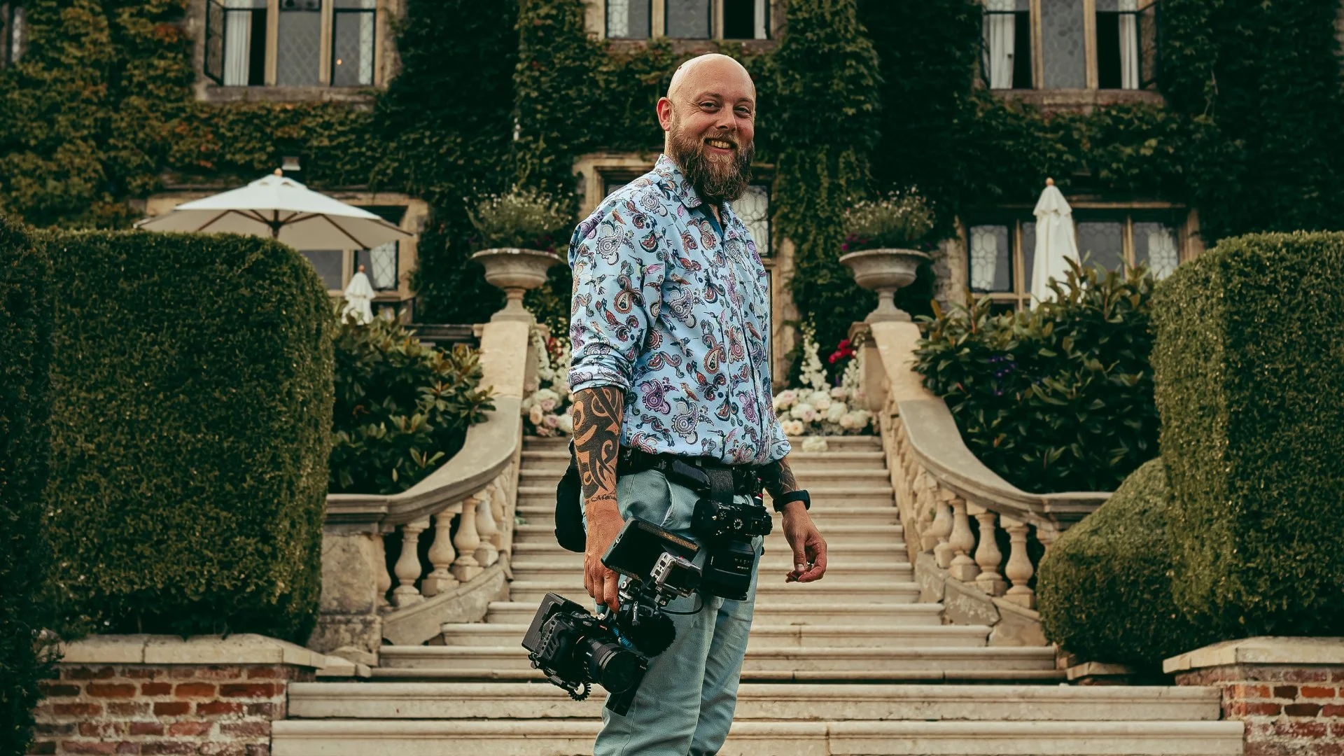 Uk wedding filmmaker Luke batchelor smiles at the camera