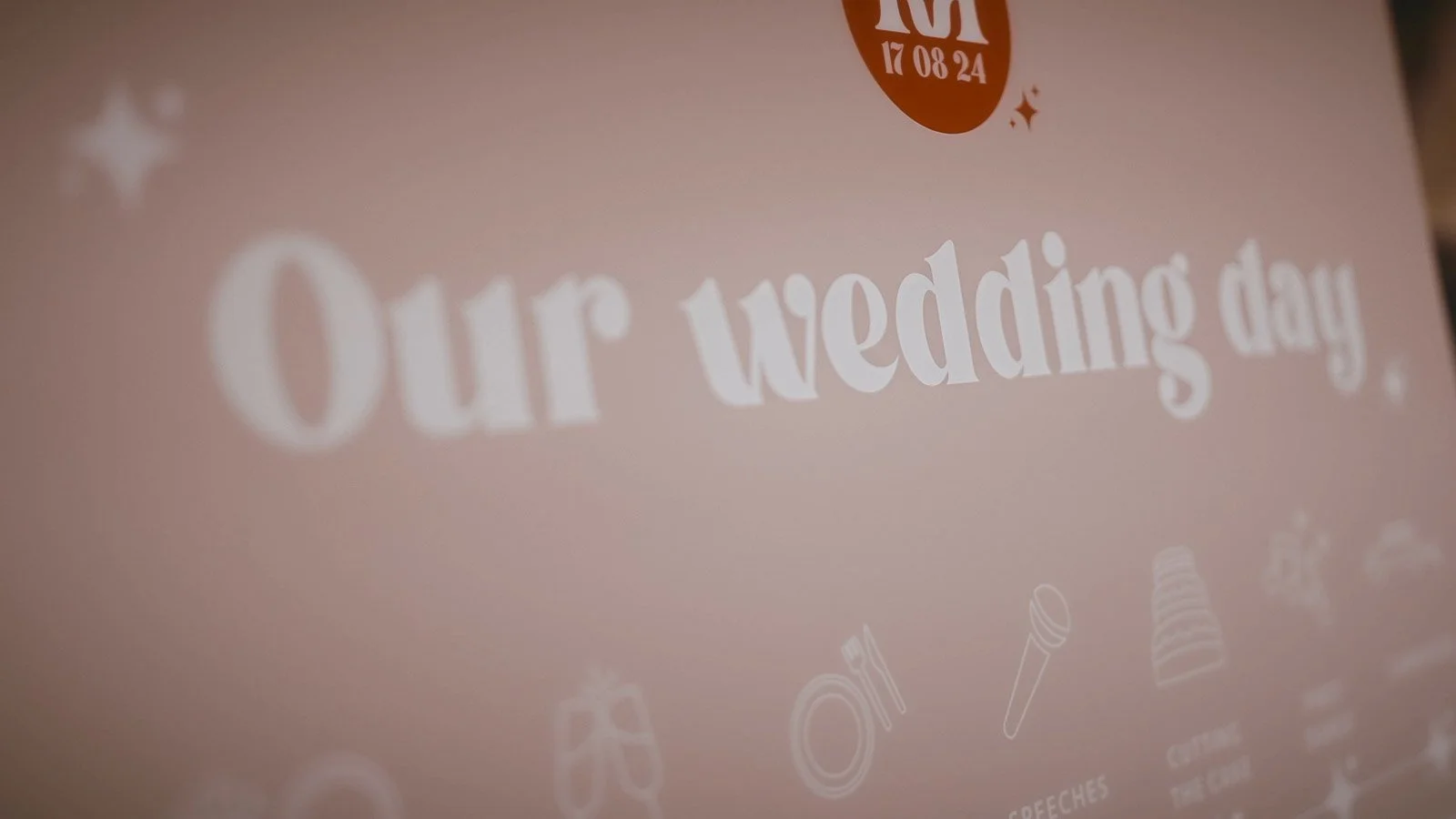 A pink welcome sign and timeline of the day from a wedding at Winters Barns, Canterbury, Kent.
