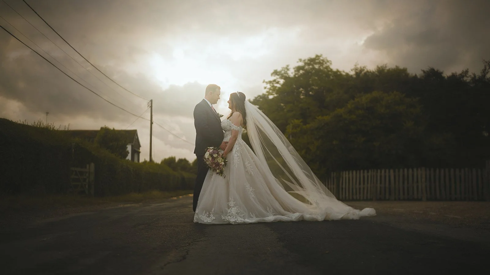 Bride’s long veil in golden-hour light during a Cooling Castle Barn wedding film