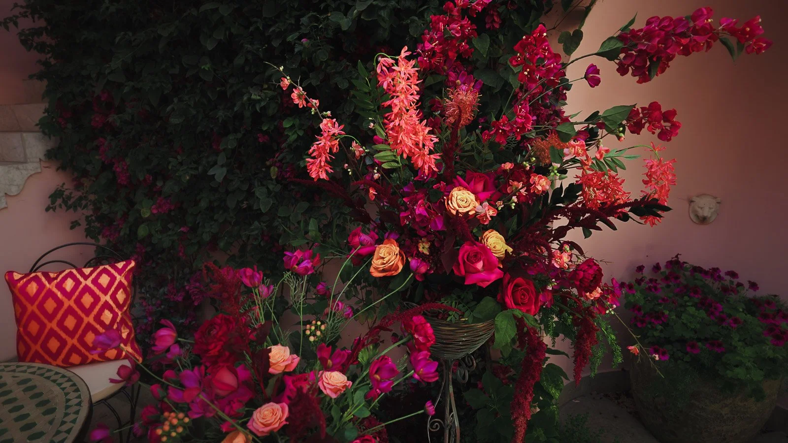 Pink and red floral design during a colourful outdoor wedding in Kent, UK.