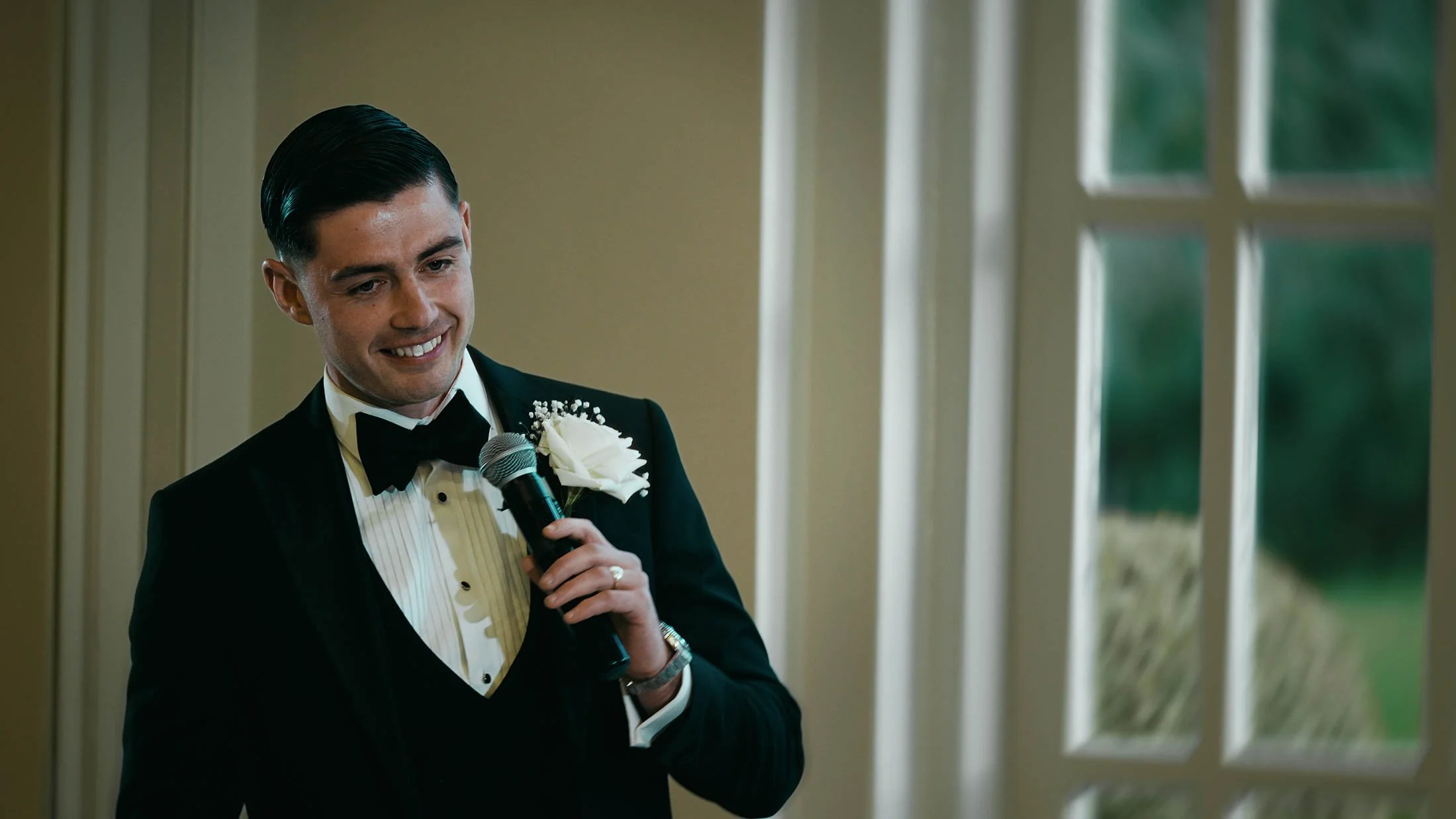 A Best Man in black-tie delivers an emotional wedding speech at The Orangery, Maidstone, as part of a storytelling wedding film in the UK.