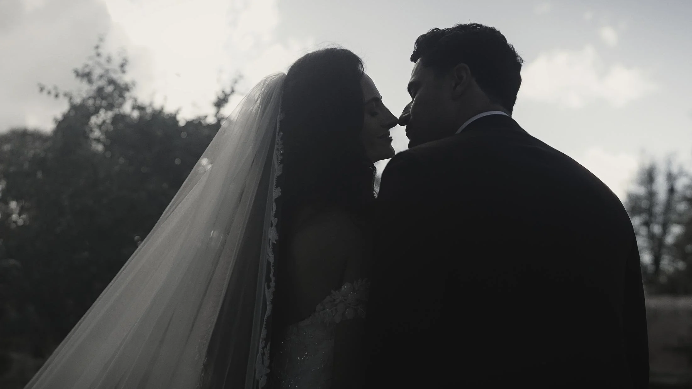 Bride and groom silhouetted against the sunset during an Elmore Court wedding in Gloucester.