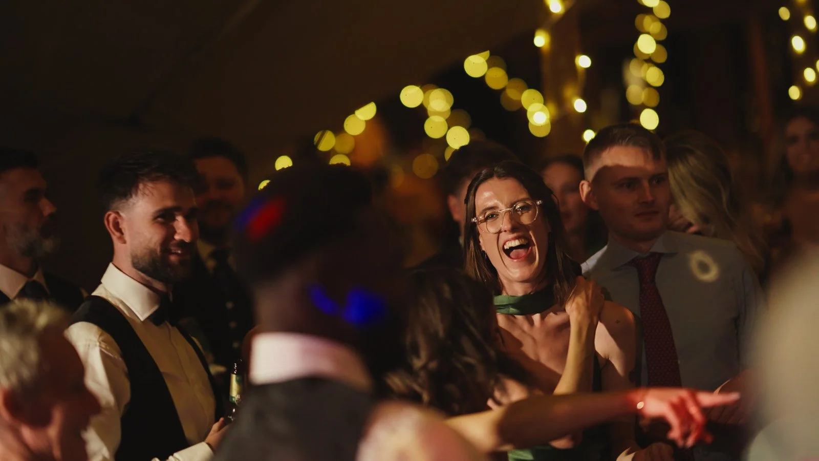 Guests and atmosphere from a colourful riverside wedding with black-tie styling and a marquee party on the Thames.