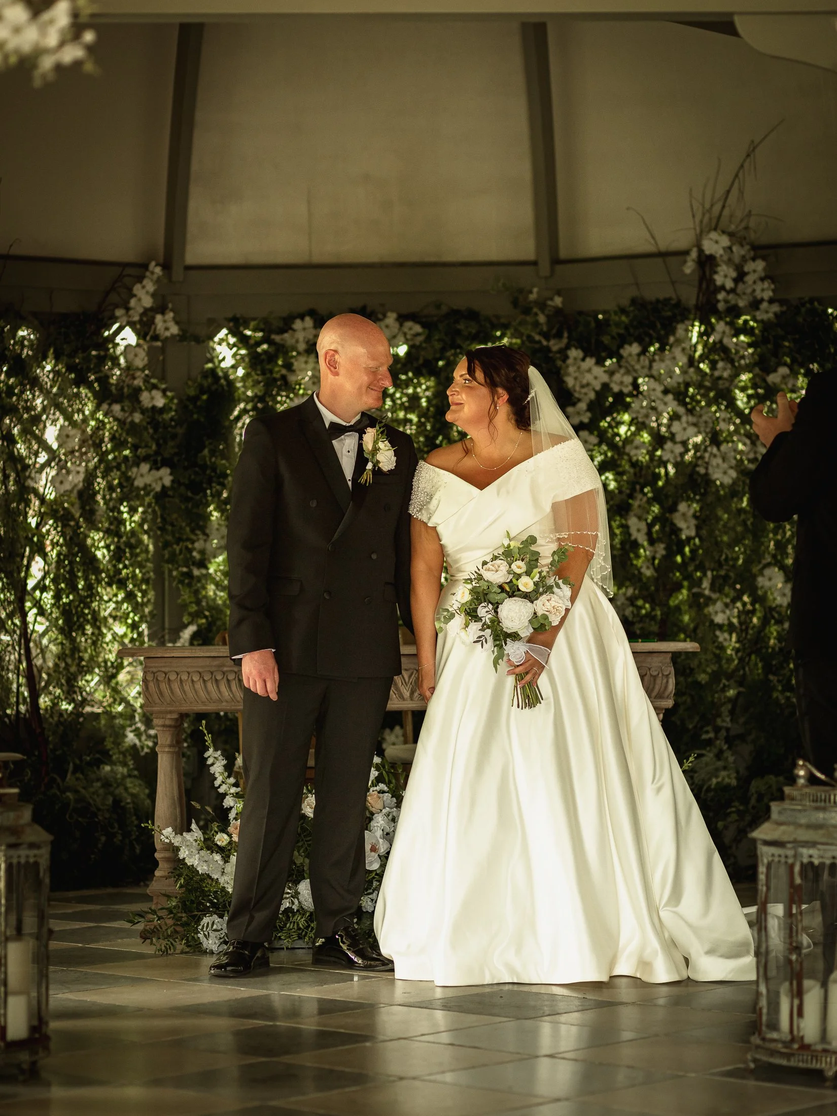 Lucy and Luke smile at each other at the end of their wedding ceremony at Port Lympne.