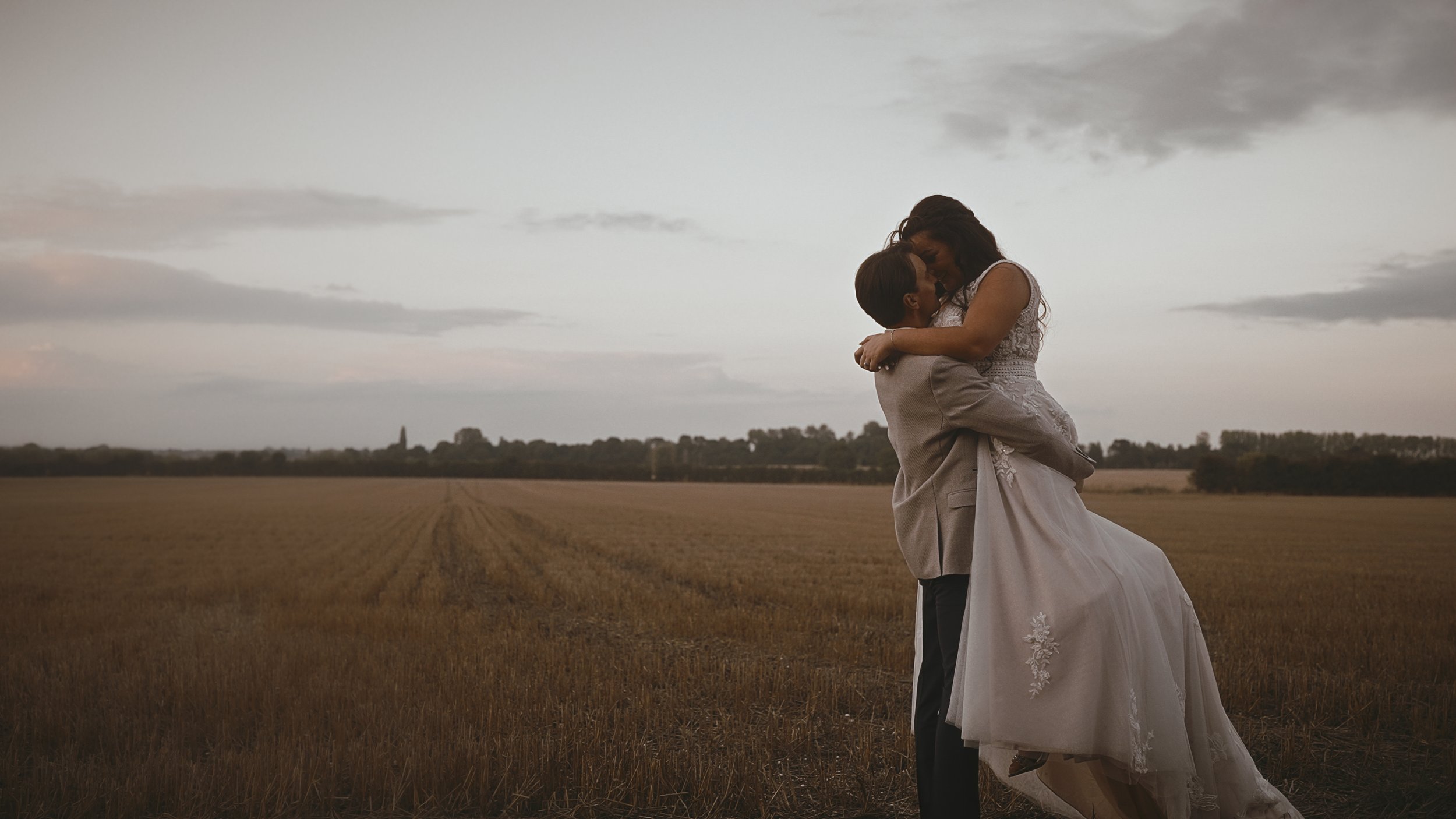 Cinematic golden hour portrait of a couple in an open field at Winters Barns in Nackington, Canterbury.