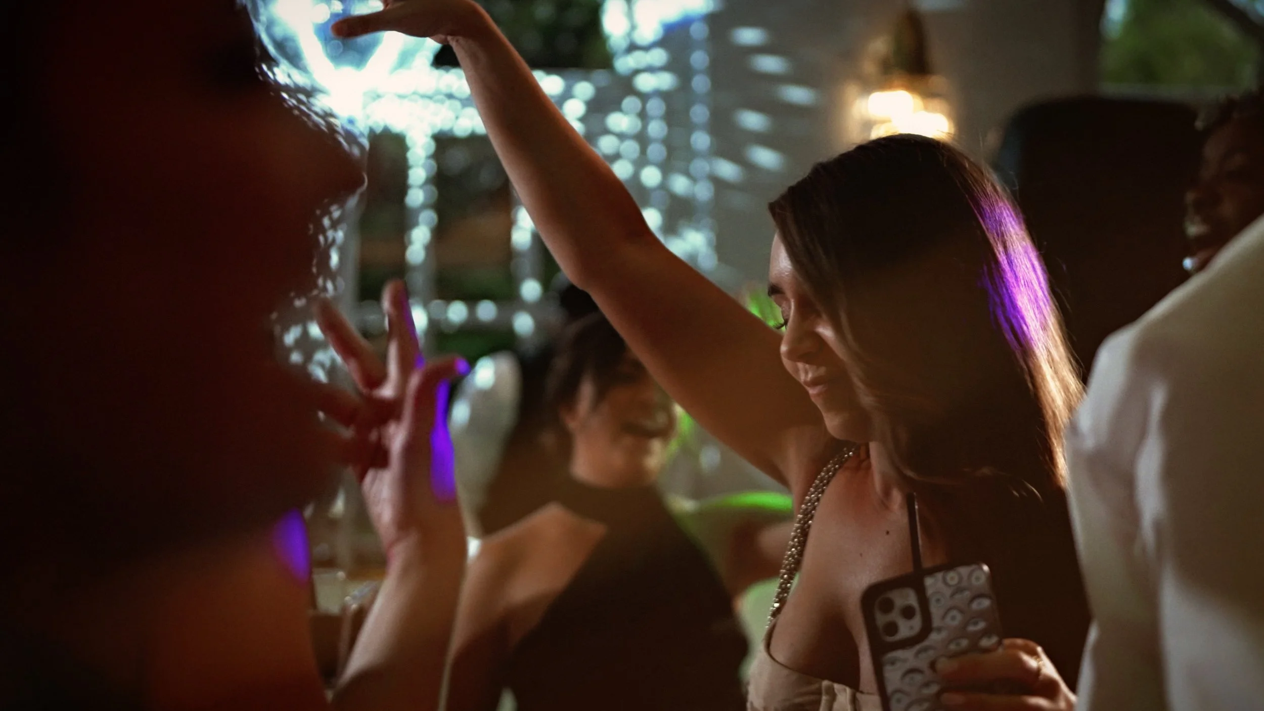 Wedding guests dancing during an evening reception at the orangery, Kent.