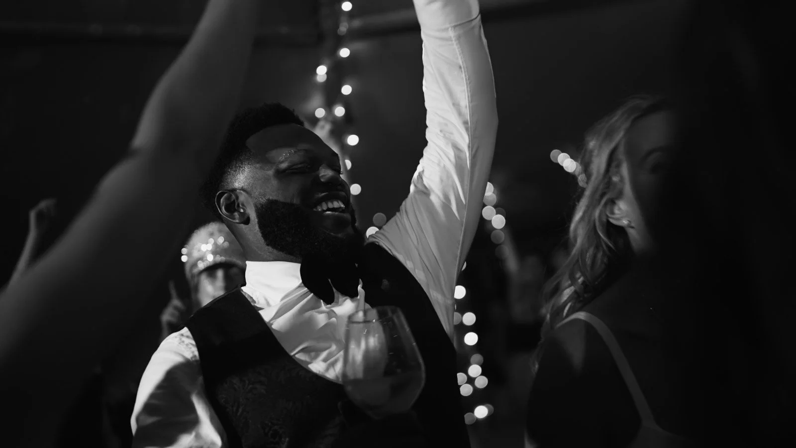 Editorial-style wedding photography from a colourful riverside celebration with bold florals and a marquee reception.