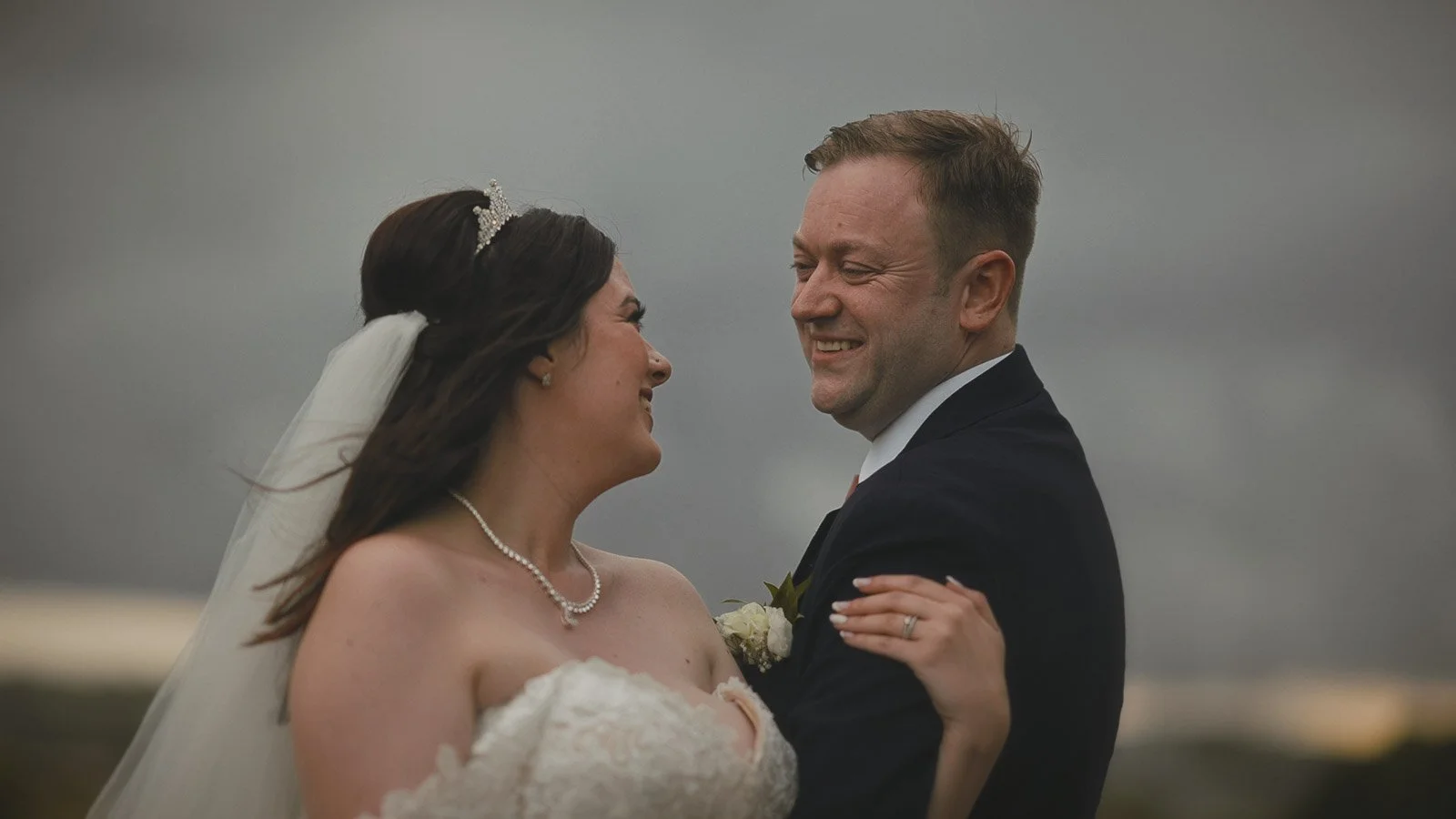 A romantic moment between a couple during their Cooling Castle Barn sunset wedding film.