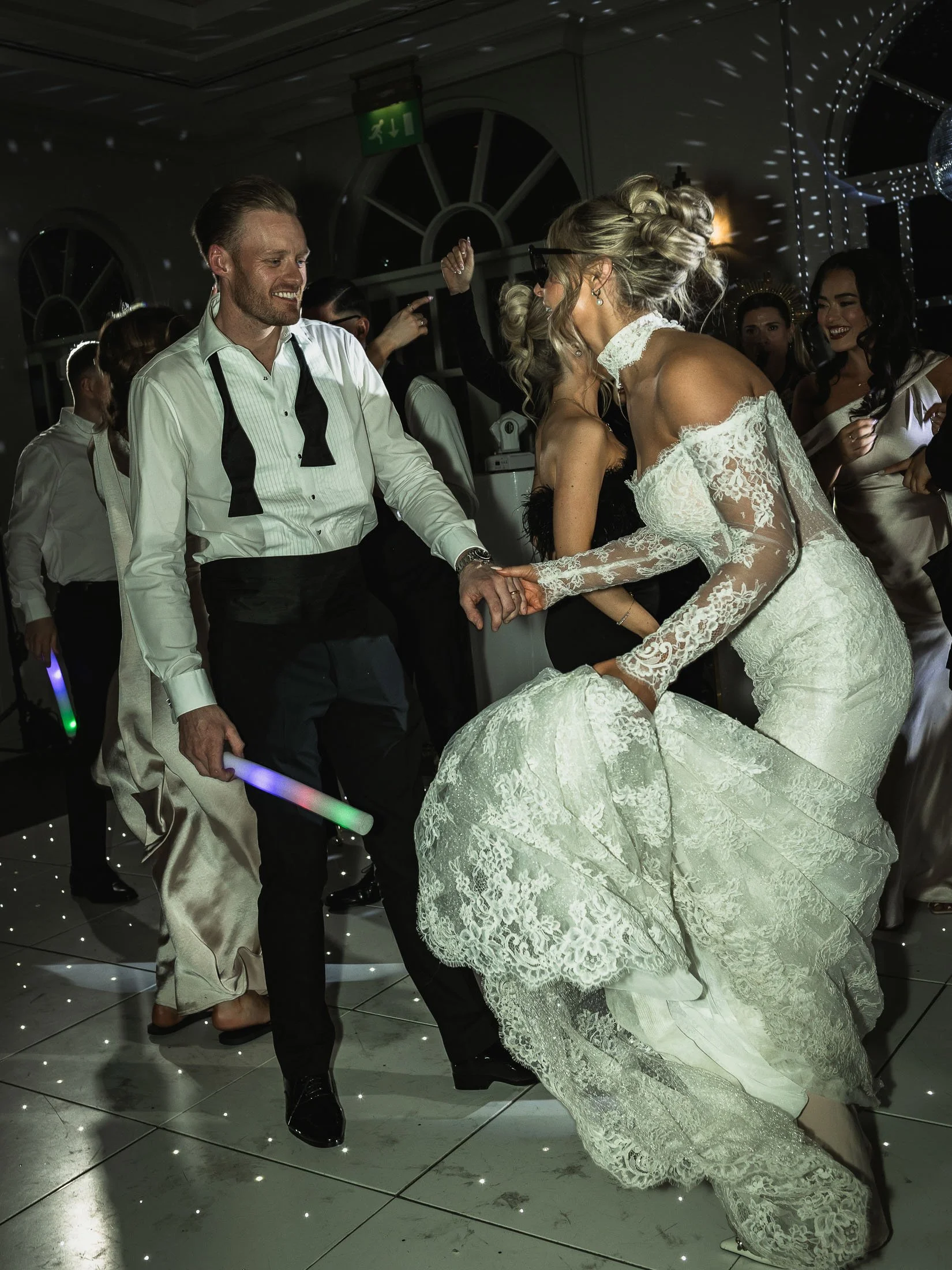 High-energy editorial wedding dance floor image of a bride and groom at The Orangery, Kent.