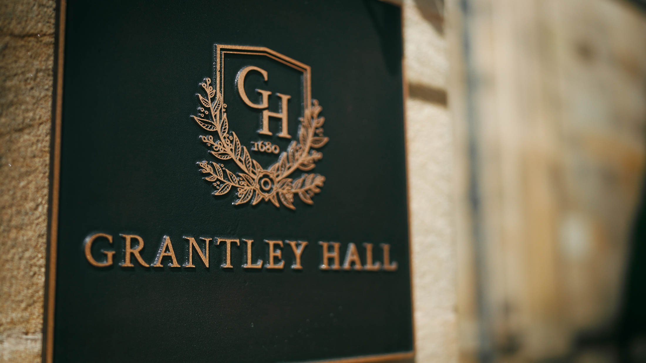 The venue emblem and welcome sign of Grantley Hall in Yorkshire.
