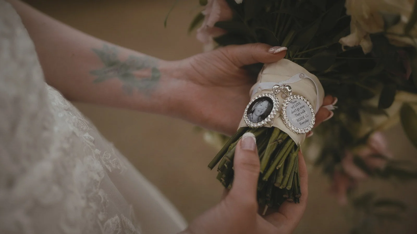 A bride holds her bouquet and pendants during a cooling castle wedding in Kent.