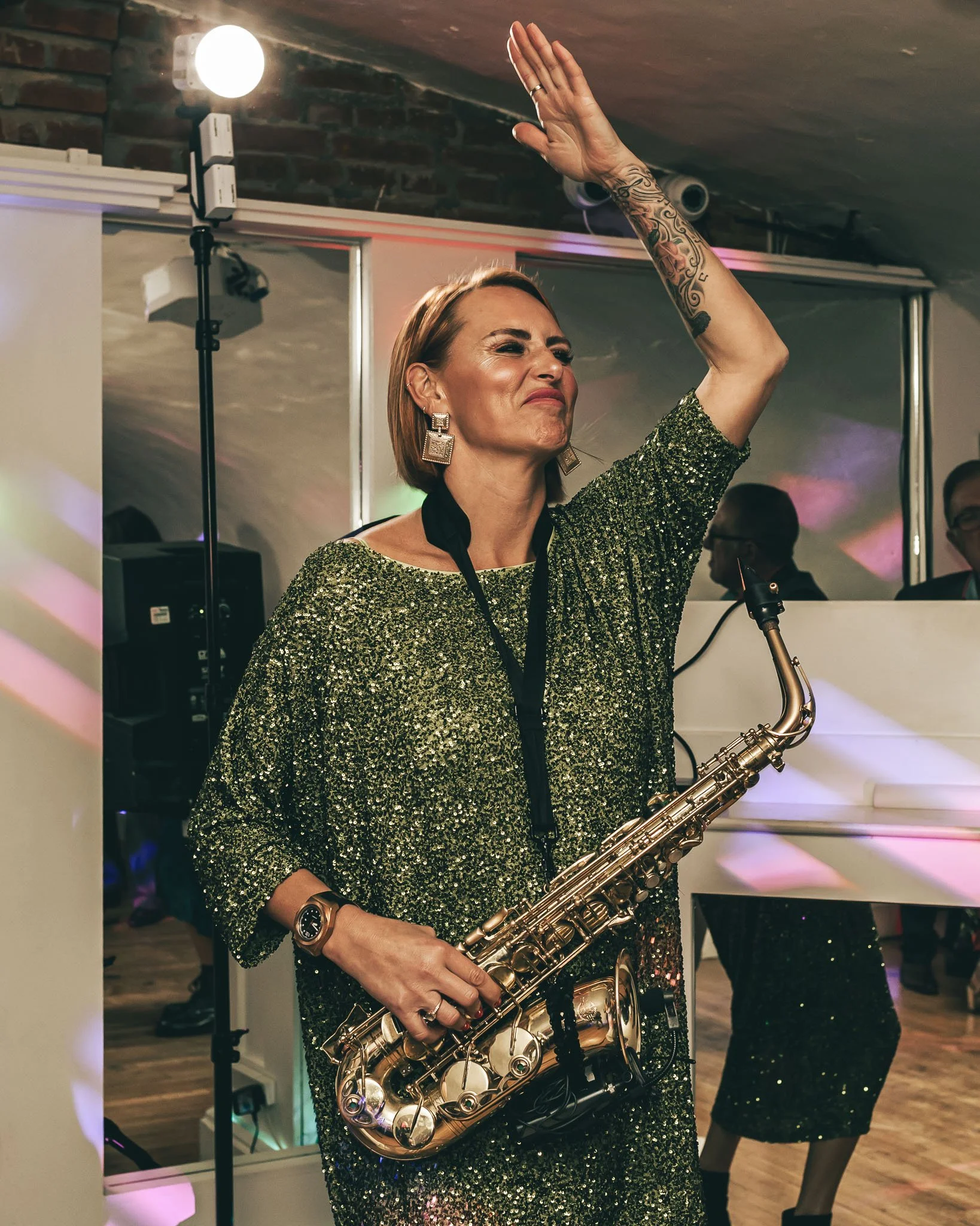 A saxophone player dances during a high-energy wedding reception, editorial wedding film and photography coverage