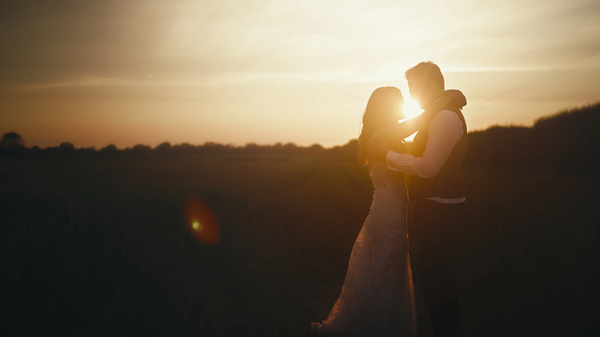 Cinematic golden hour sequence in the wheat field near The Old Kent Barn, captured for an editorial wedding film.