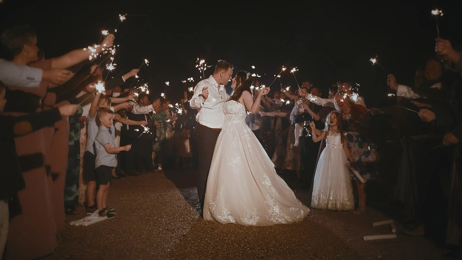 Late evening portraits filmed near Cooling Castle Barn wedding venue with sparklers