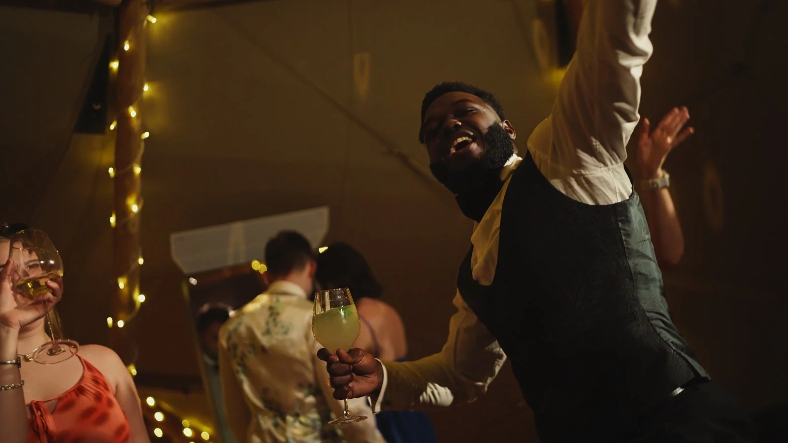 Guests and atmosphere from a colourful riverside wedding with black-tie styling and a marquee party on the Thames.