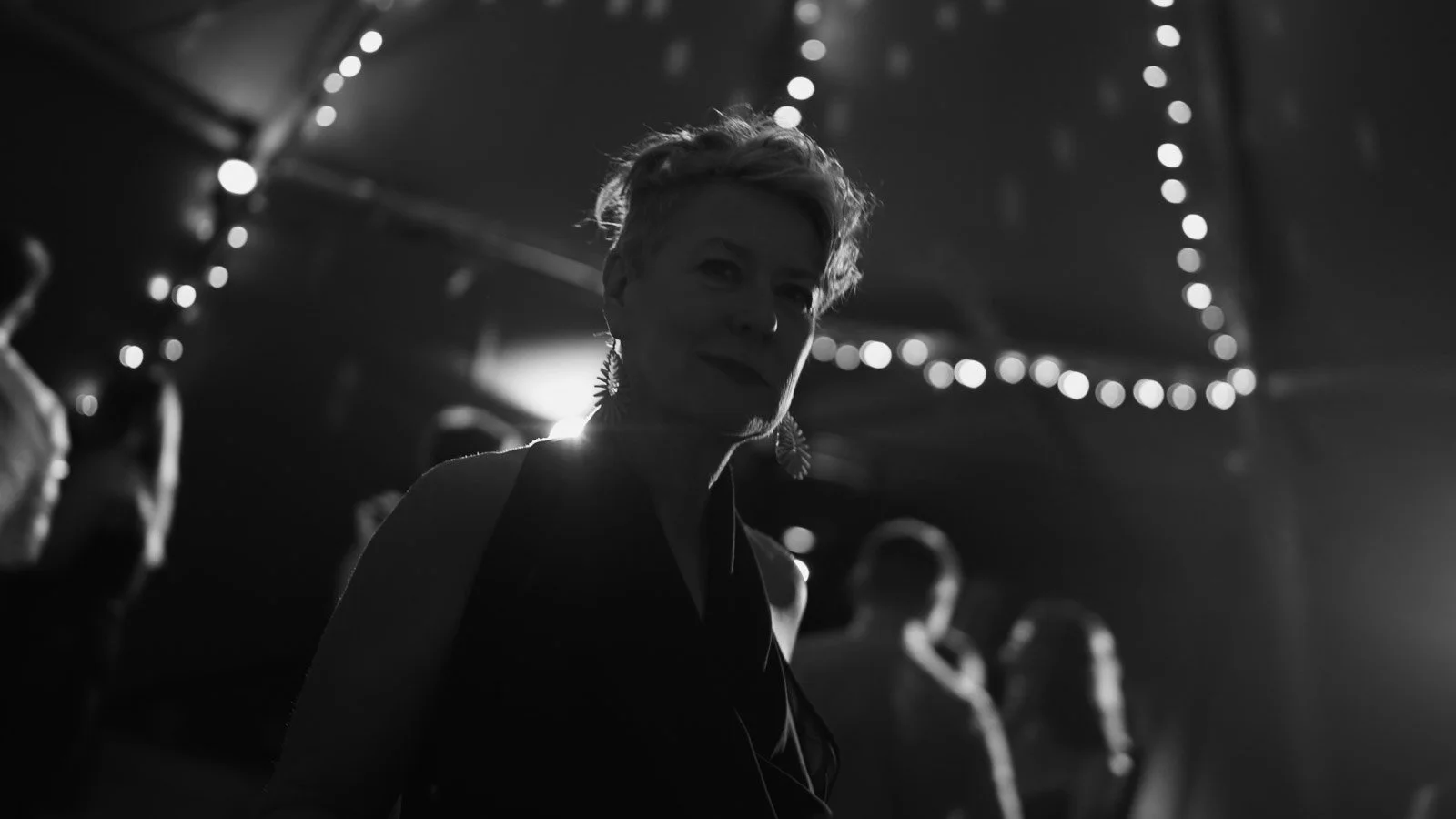 Editorial-style wedding photography from a colourful riverside celebration with bold florals and a marquee reception.