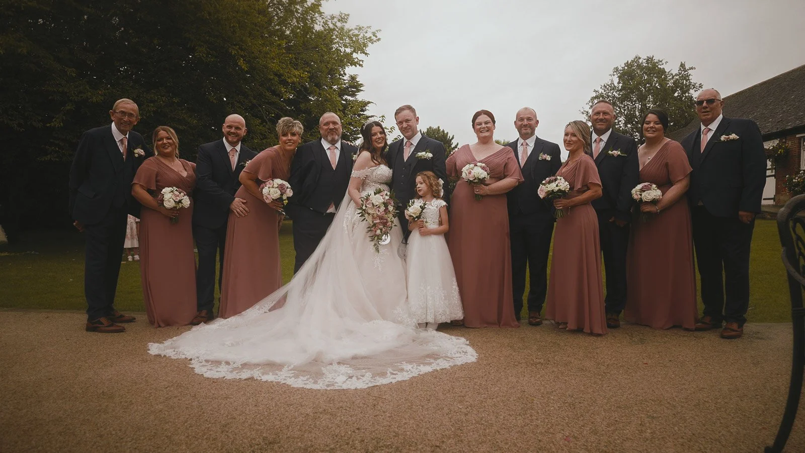 A bridal party pose for a group shot during a Cooling Castle wedding film in Kent.