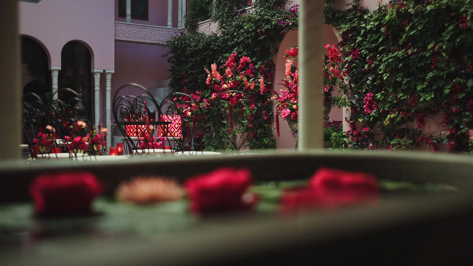 Floral detail shot with bold pink and red tones, fine art styling