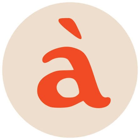 Red letter 'a' with an accent mark on a beige background.