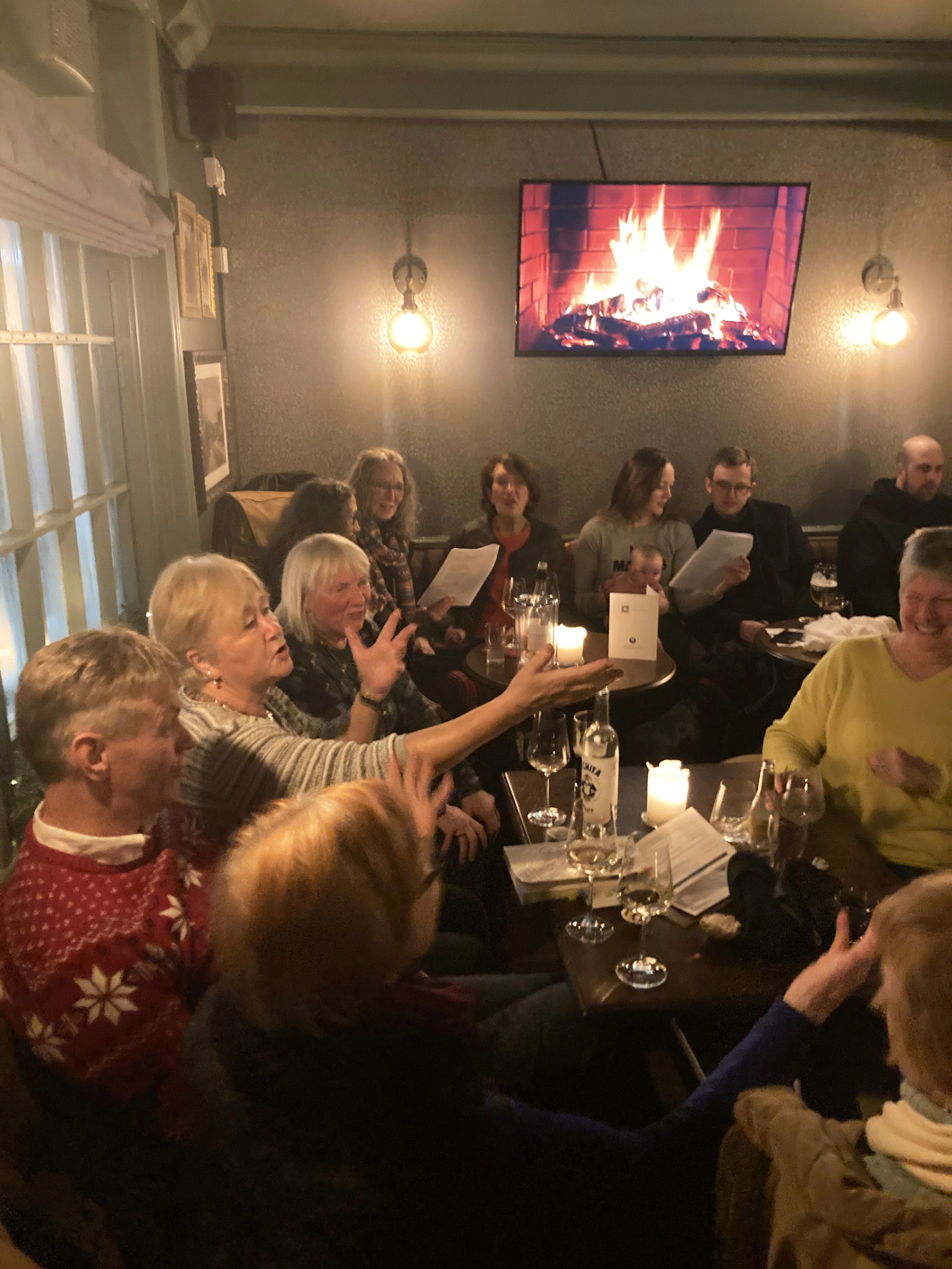 Customers joyfully singing carols at The Windsor Castle pub in East FInchley