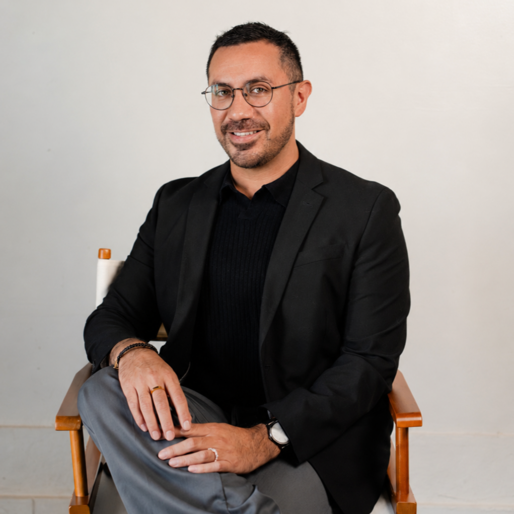 Headshot profile photo of Jon Ramirez posing