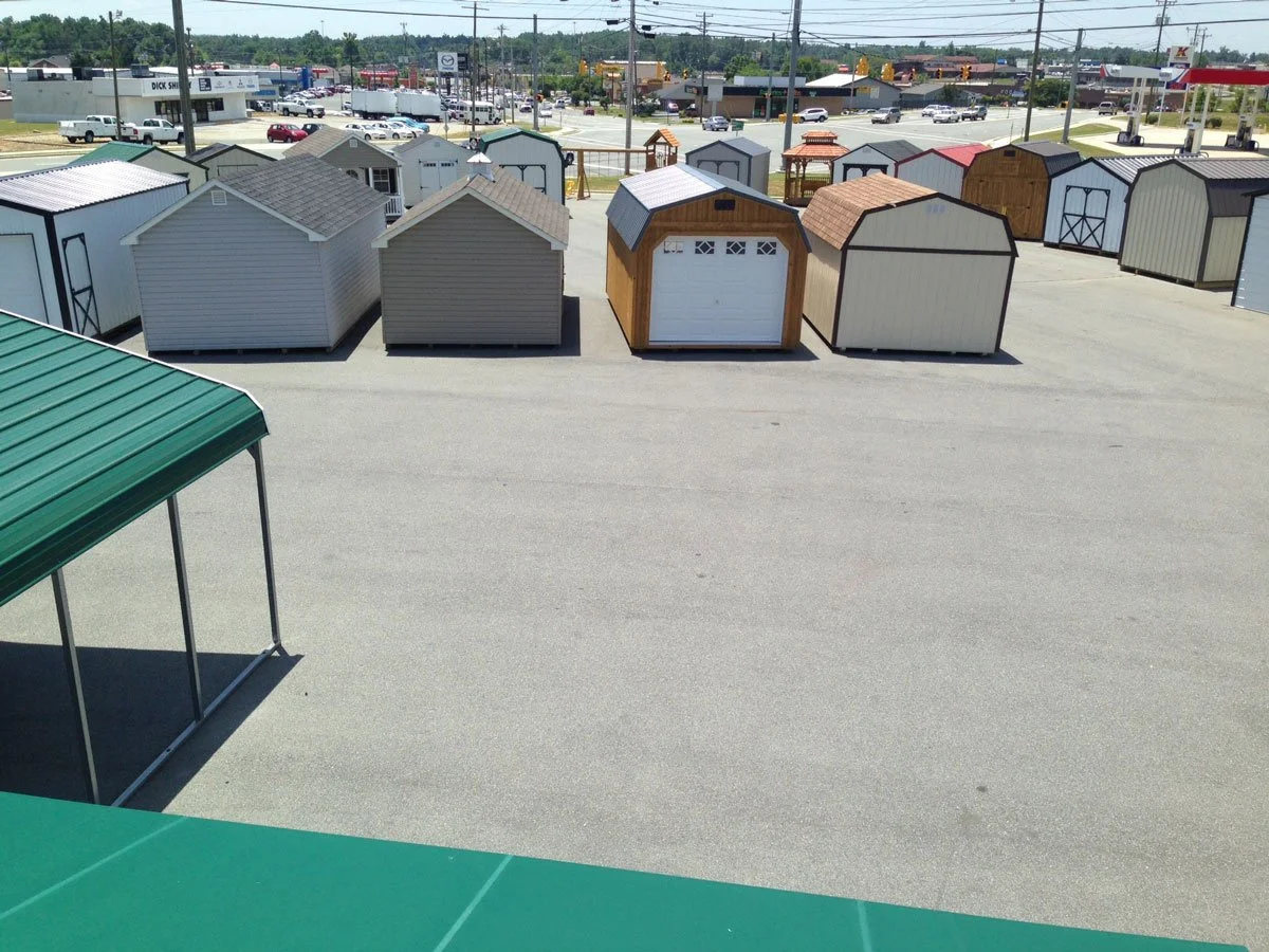 Picture of the Burlington Liberty Sheds lot with multiple sheds and carports onsite.