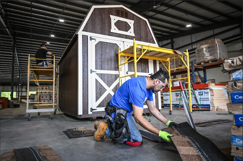 Liberty Sheds builder in Mocksville, NC manufacturing facility preparing architectural shingles and materials for a handcrafted lofted barn.