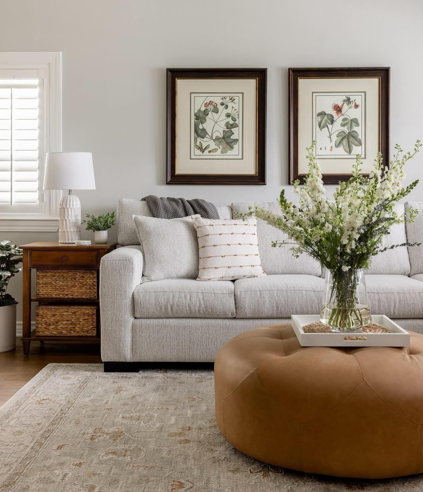 Designing a living room that is both inviting and cohesive for a couple involves thoughtful consideration of color schemes, furniture choices, and personalized touches. 

On this project the homeowner really liked her existing artwork and some key fu