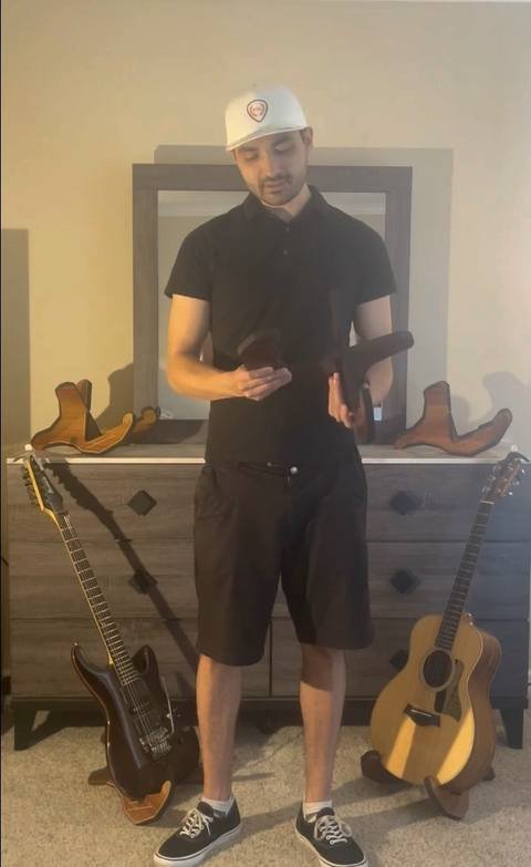 John, founder of PGL, with an electric and acoustic guitar