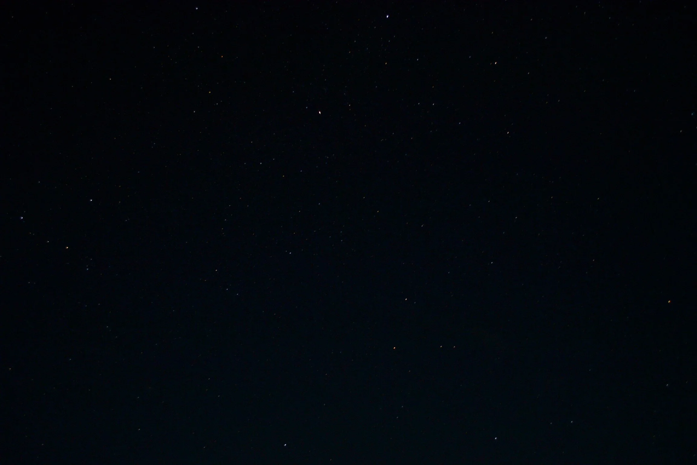 Starry night sky with scattered bright stars on a dark background.
