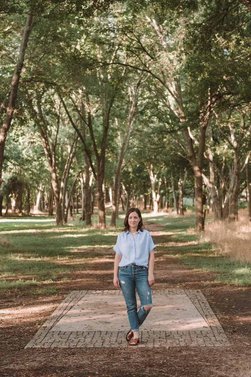 Rebecca Magee, Sister Seasons' founder, stands in a grove of trees