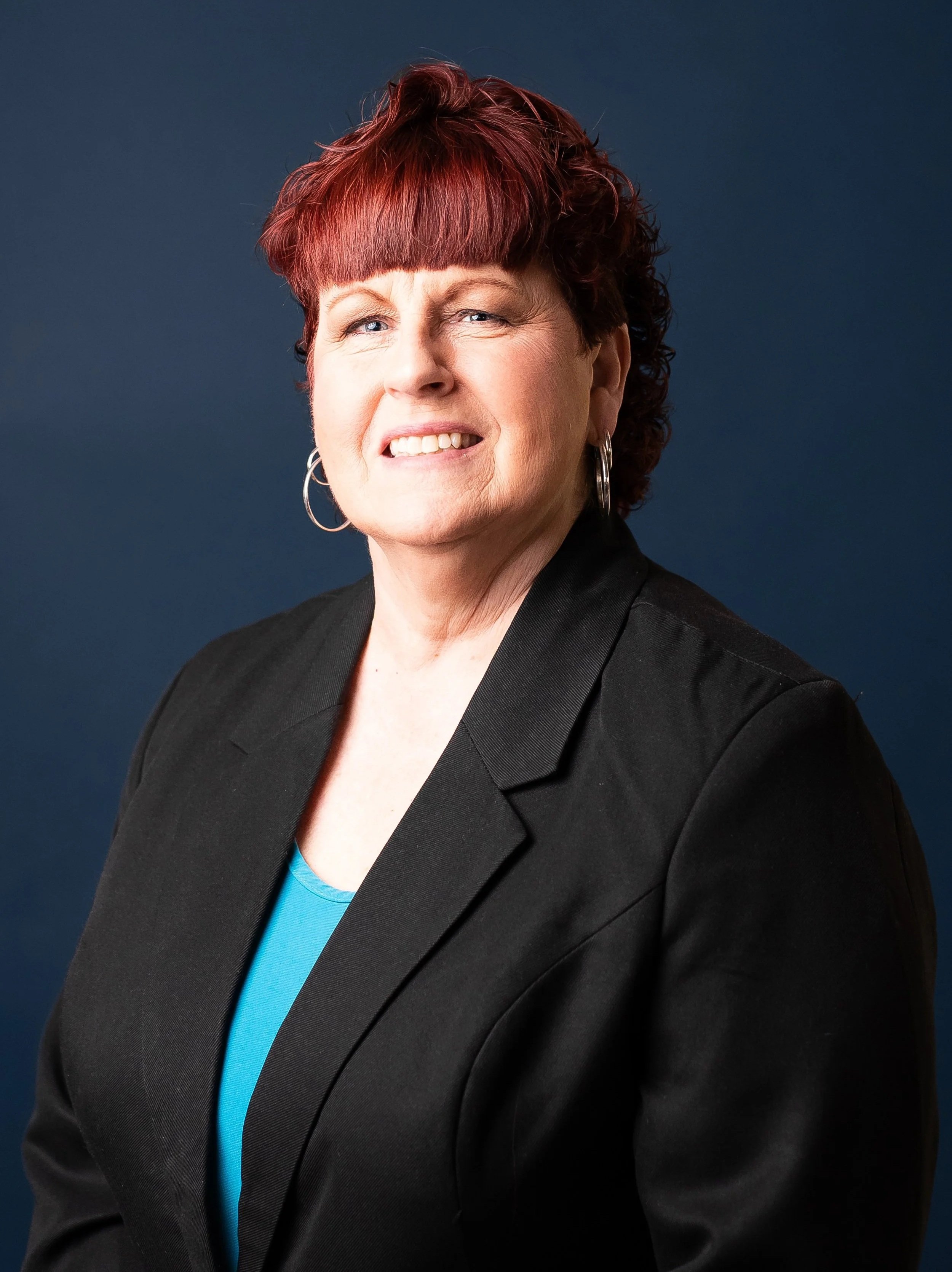 an image of Judy Schuler smiling at the camera
