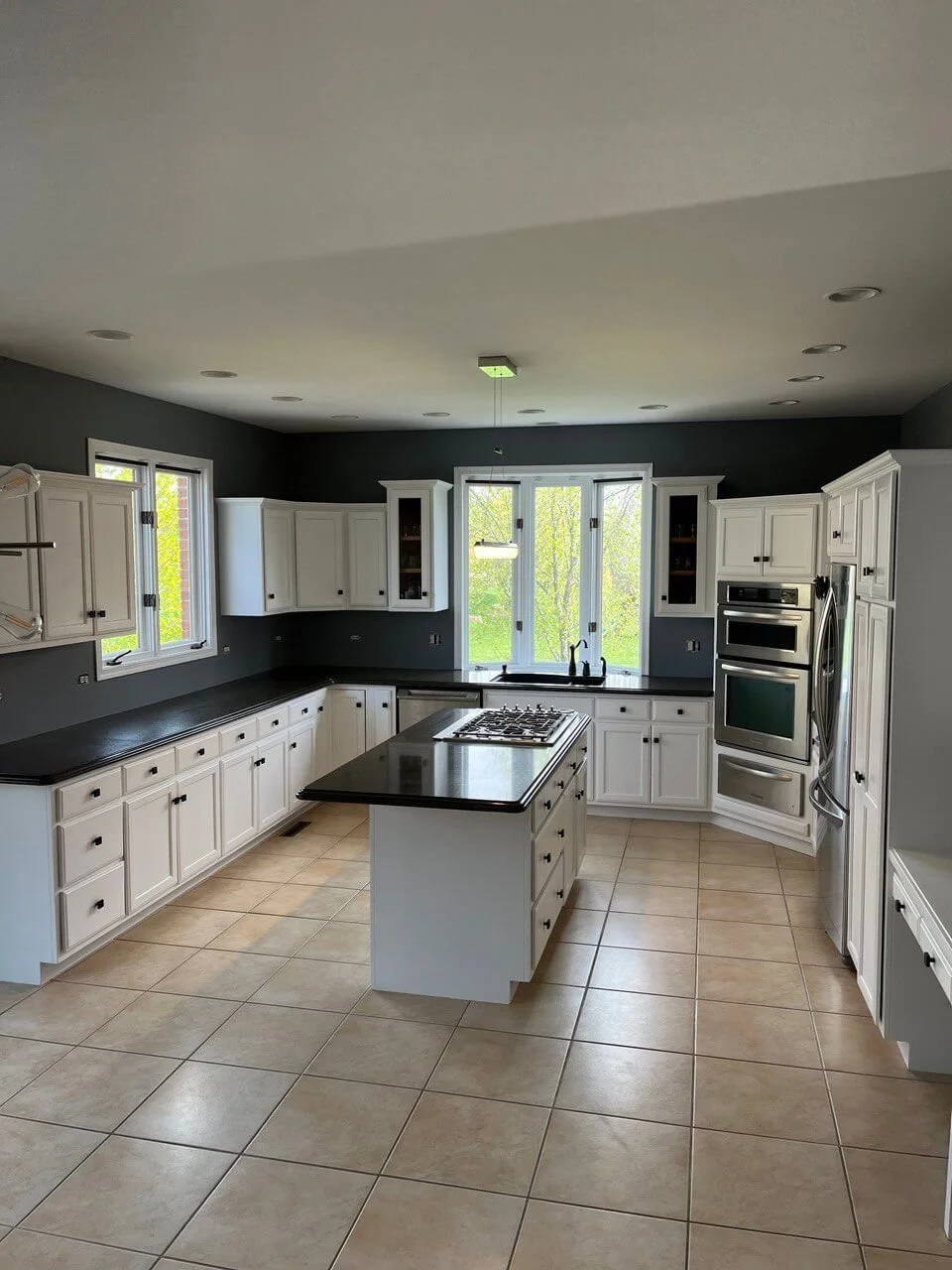 Elegant Kitchen Transformation: Satin White Cabinets and Dark Gray Walls — O. A. Construction