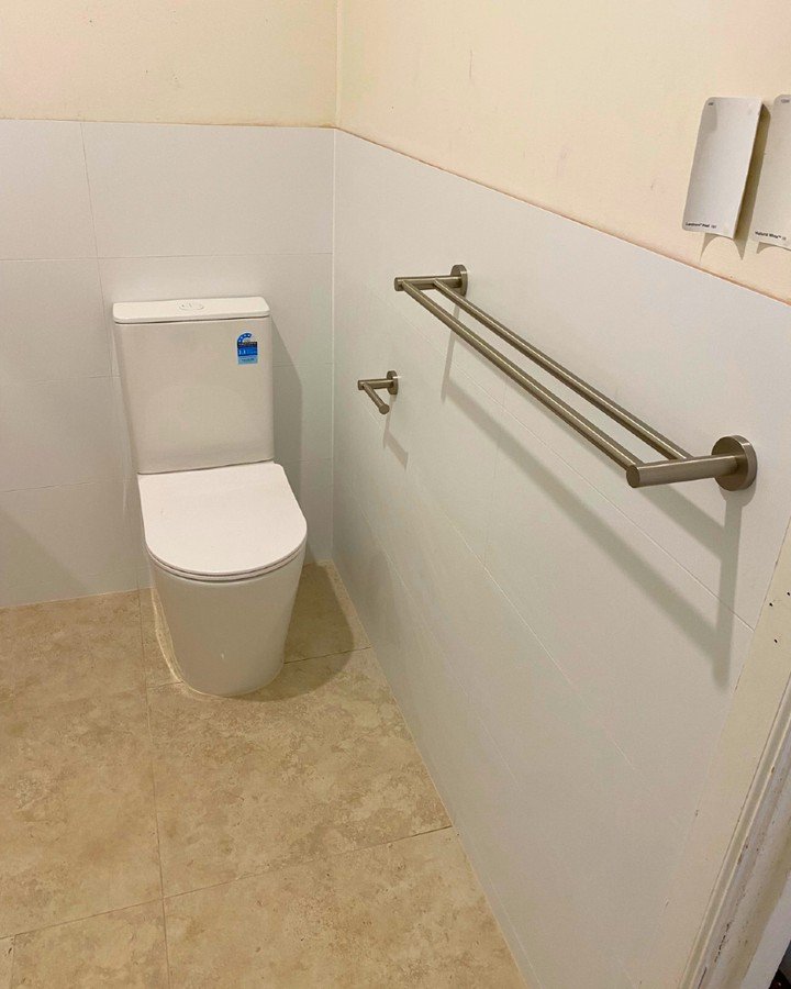 🚽 Clean Lines &amp; Practical Design

Simplicity meets function in this toilet zone.
The soft white wall tiles create a fresh, clean look while the brushed nickel fixtures add a modern touch. Featuring a dual towel rail and paper holder, the space i