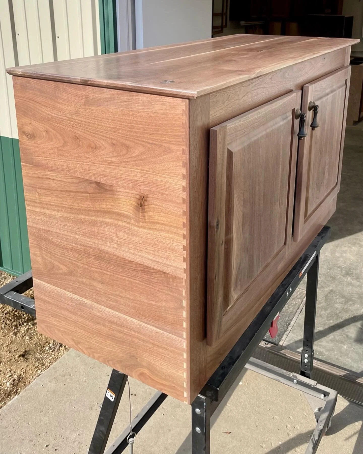Zoom in on the front corner &amp; check out the dovetails on this solid walnut cabinet! &thinsp;
&thinsp;
Everything on this cabinet is 100% handmade with soft close doors, raised panel doors and of course the dovetails down the two front corners.