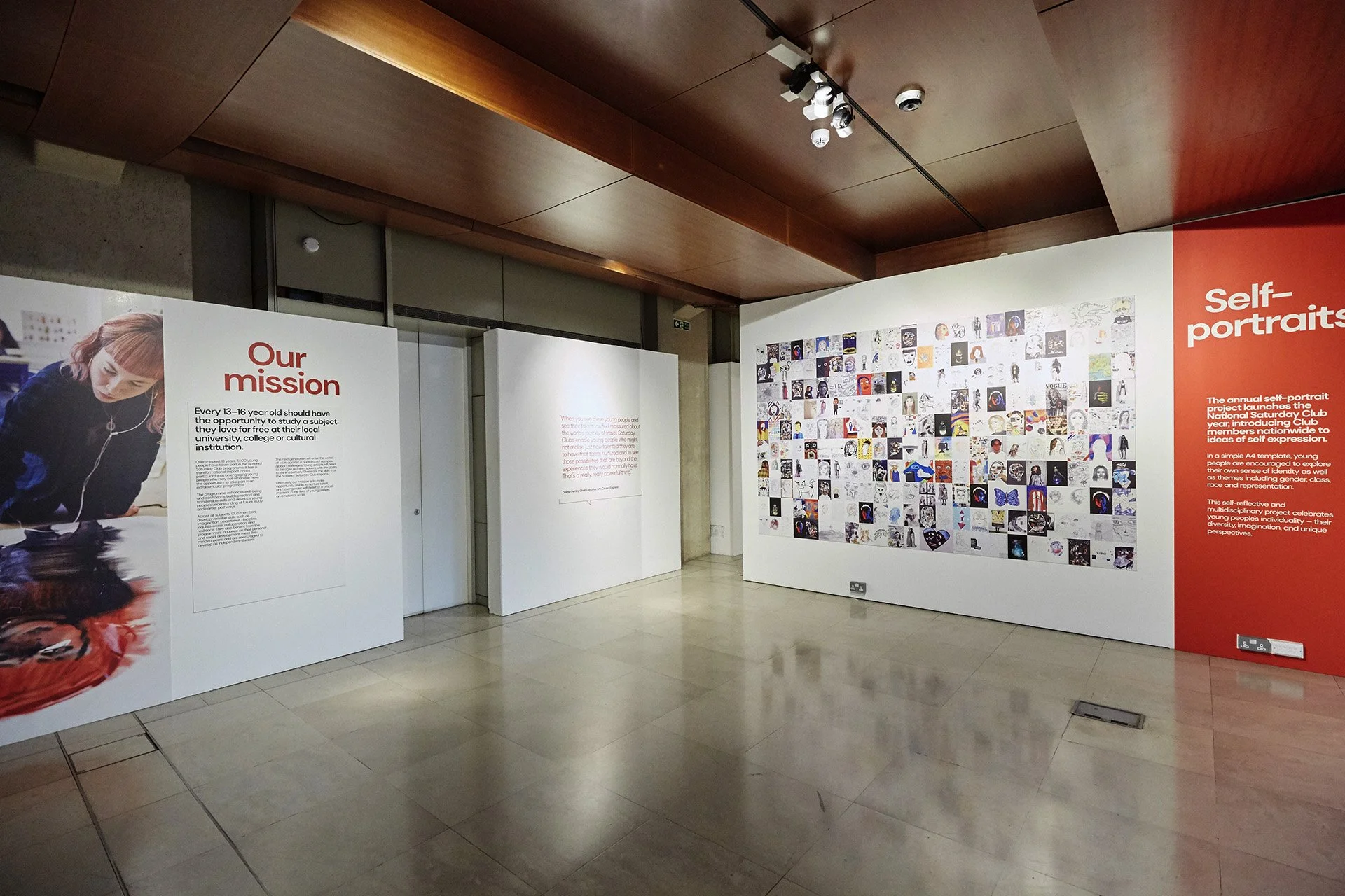Display boards at the National Saturday Club Summer Show. One board reads "Our mission"; another reads "Self-portraits"