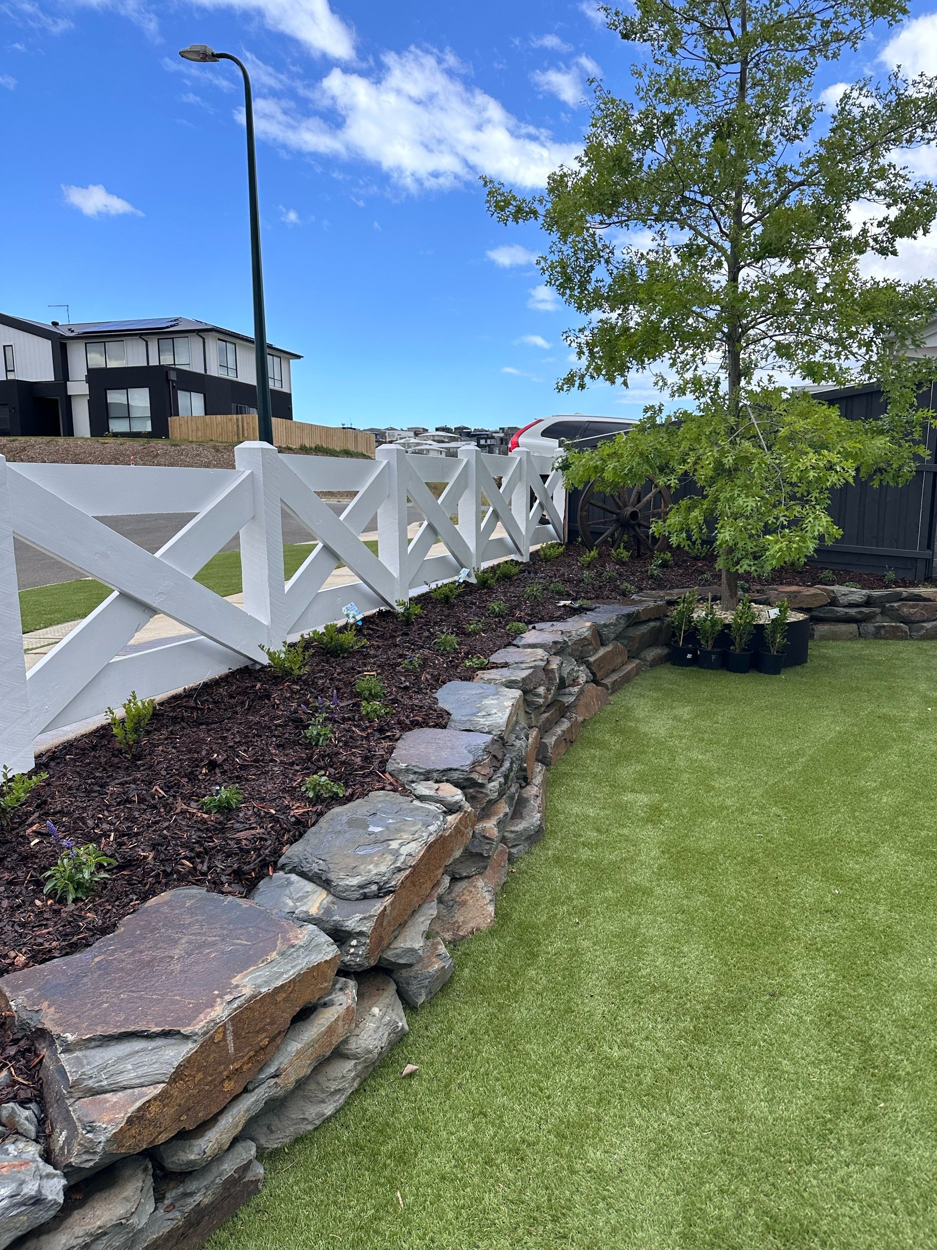 Natural rock wall formation and farmhouse-style criss-cross fence