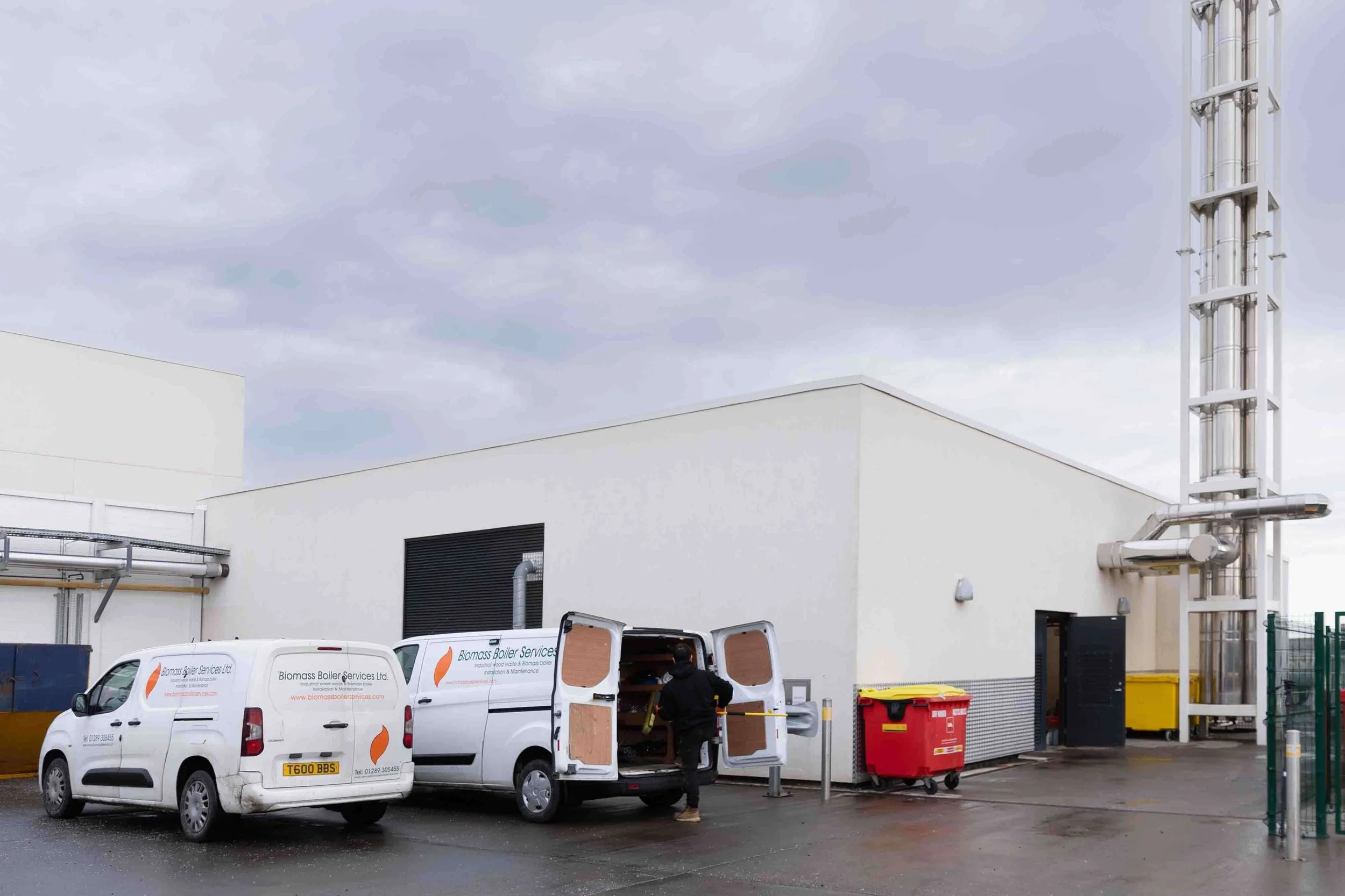Biomass boiler engineers working on an industrial heating system