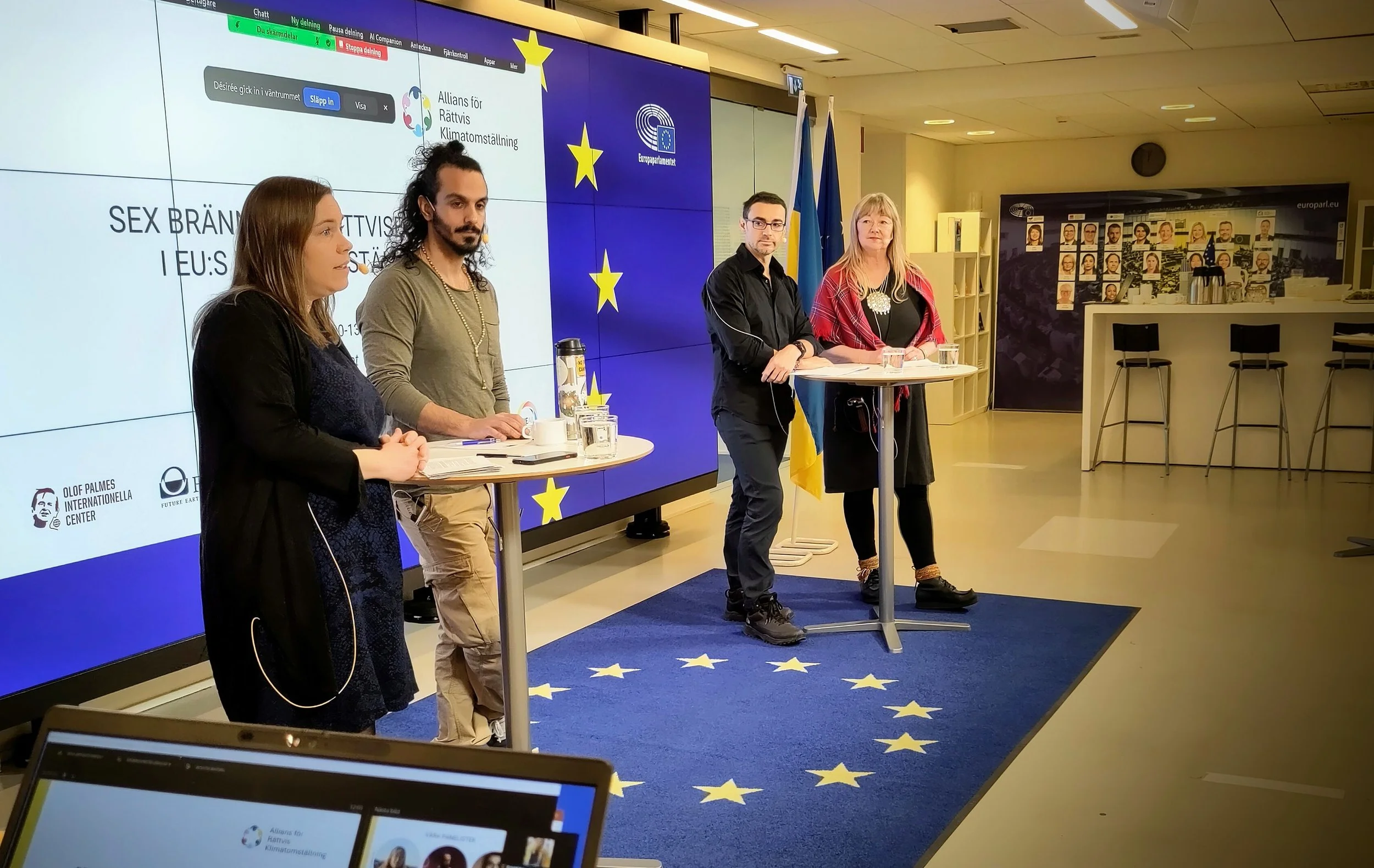 Deltagare på scen under seminarium med EU-flaggan i bakgrunden