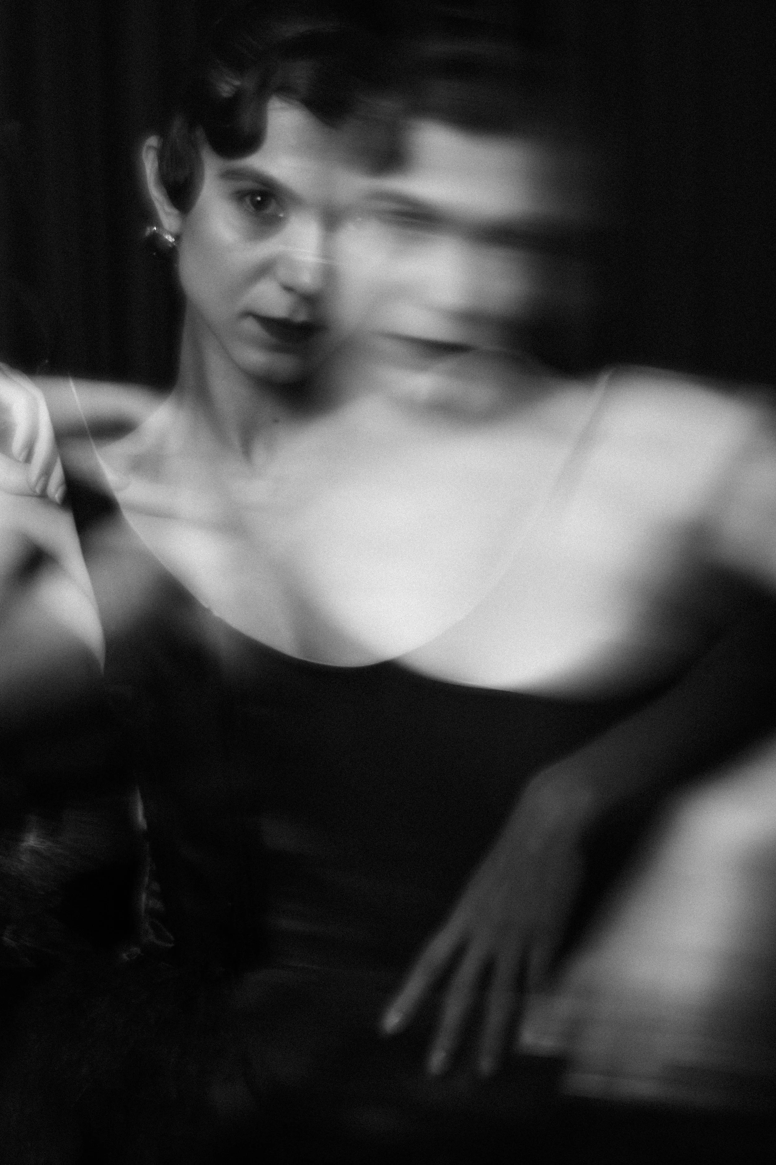 Black and white double exposure style portrait of Sorina Rotaru, face partially distorted through glass