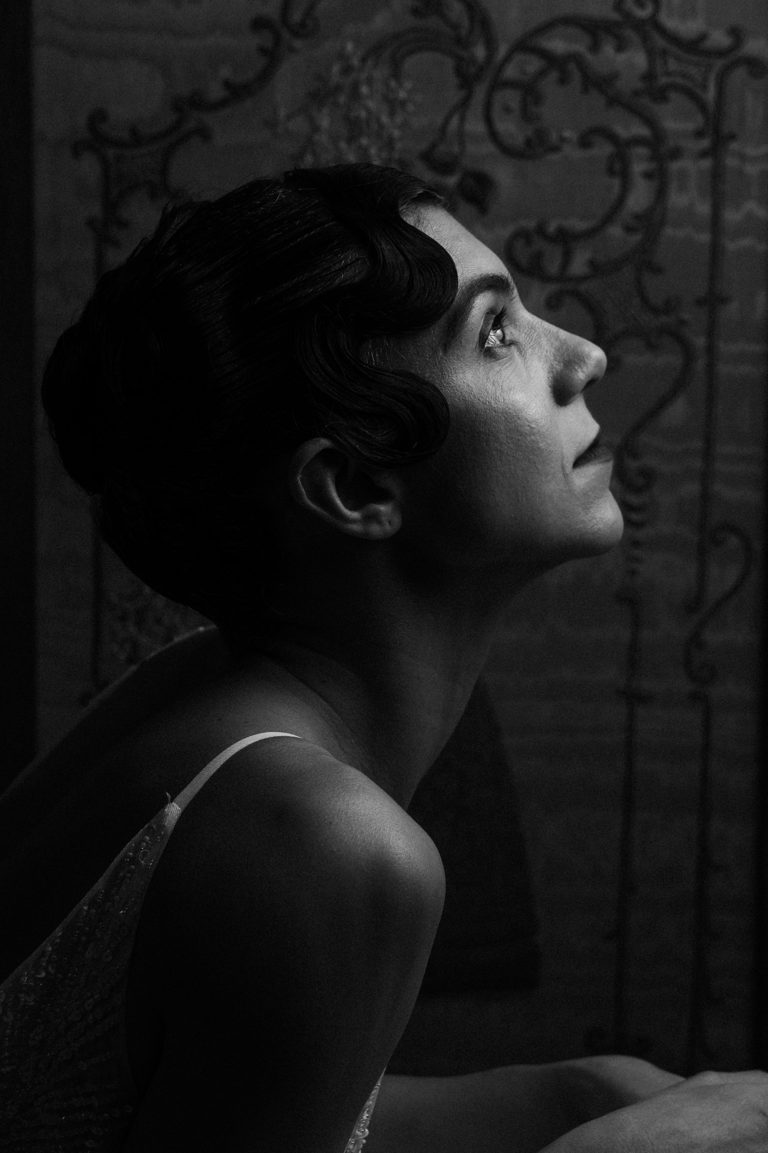 Black and white profile portrait of jazz singer Sorina Rotaru, vintage finger wave hairstyle, soft lighting