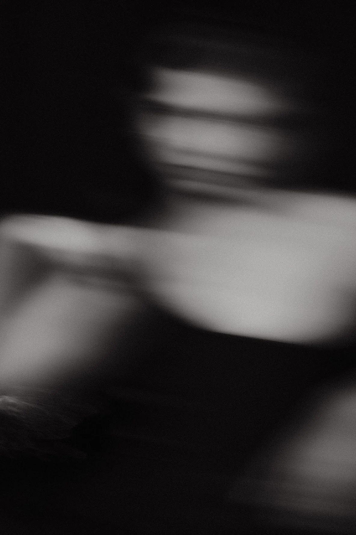 Abstract black and white glass distortion photo, blurred shapes from an in-camera technique