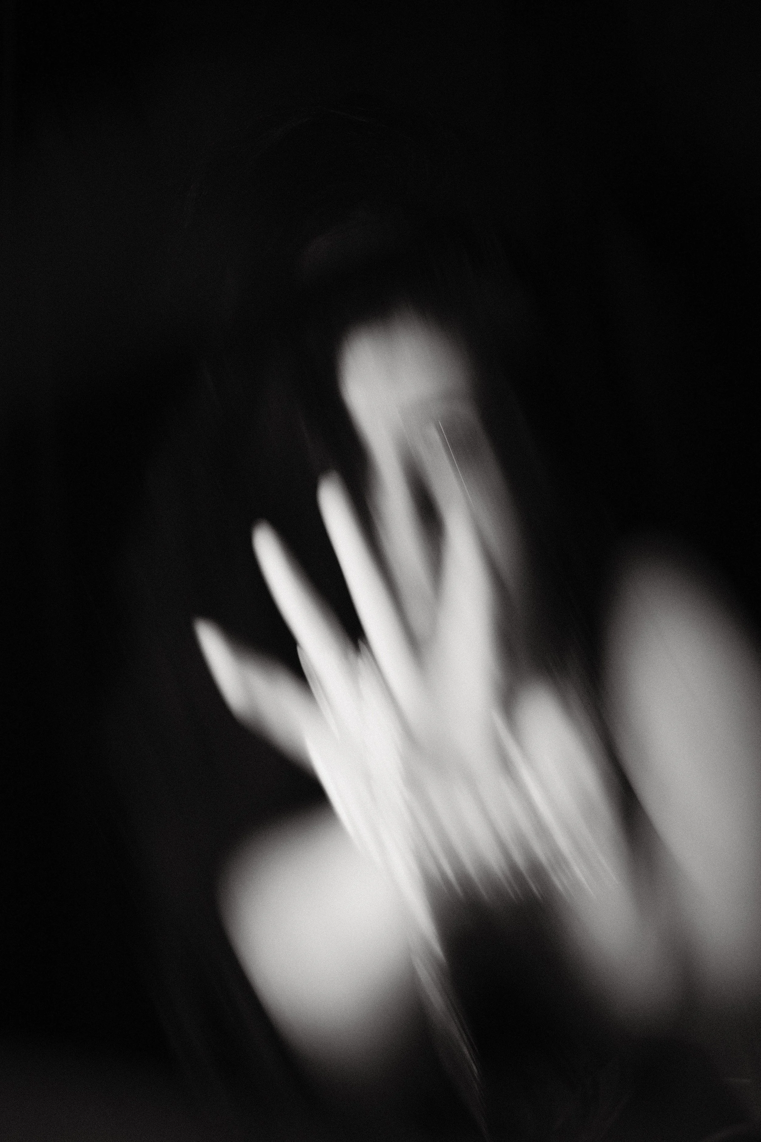 Close-up black and white image of a fork with a blurred background.